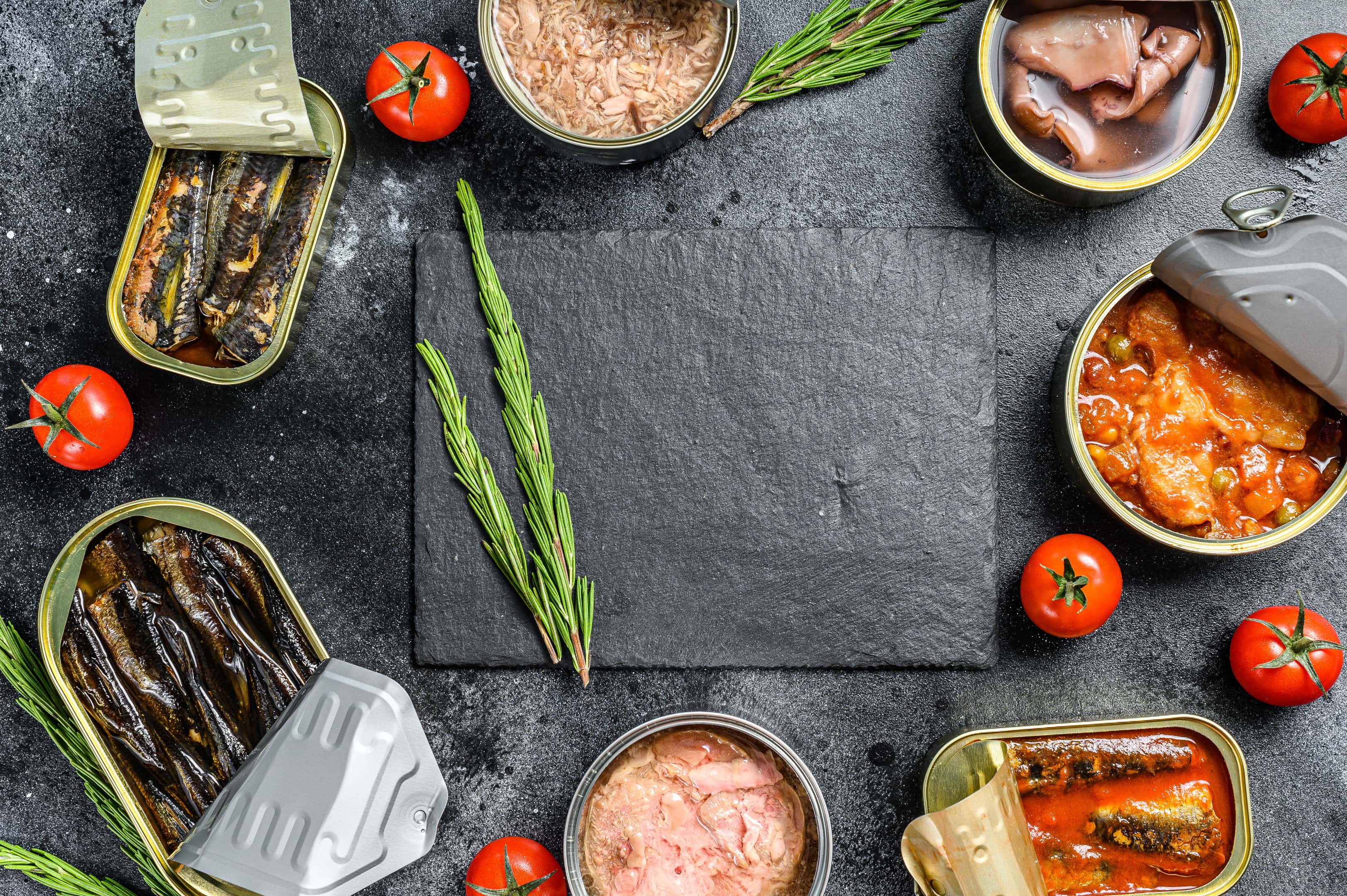 Assortment cans of different types fish on black background