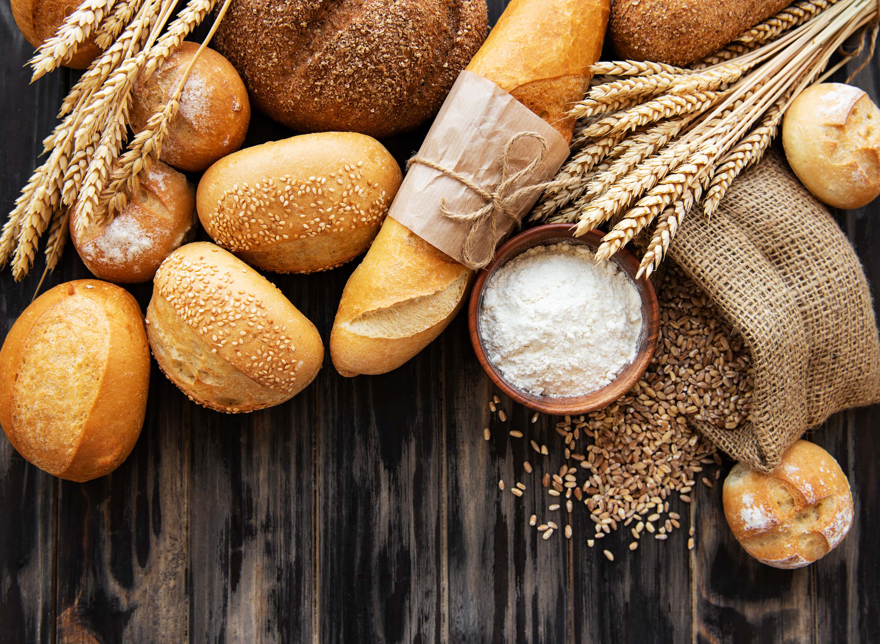 Assortment of baked bread on wooden table