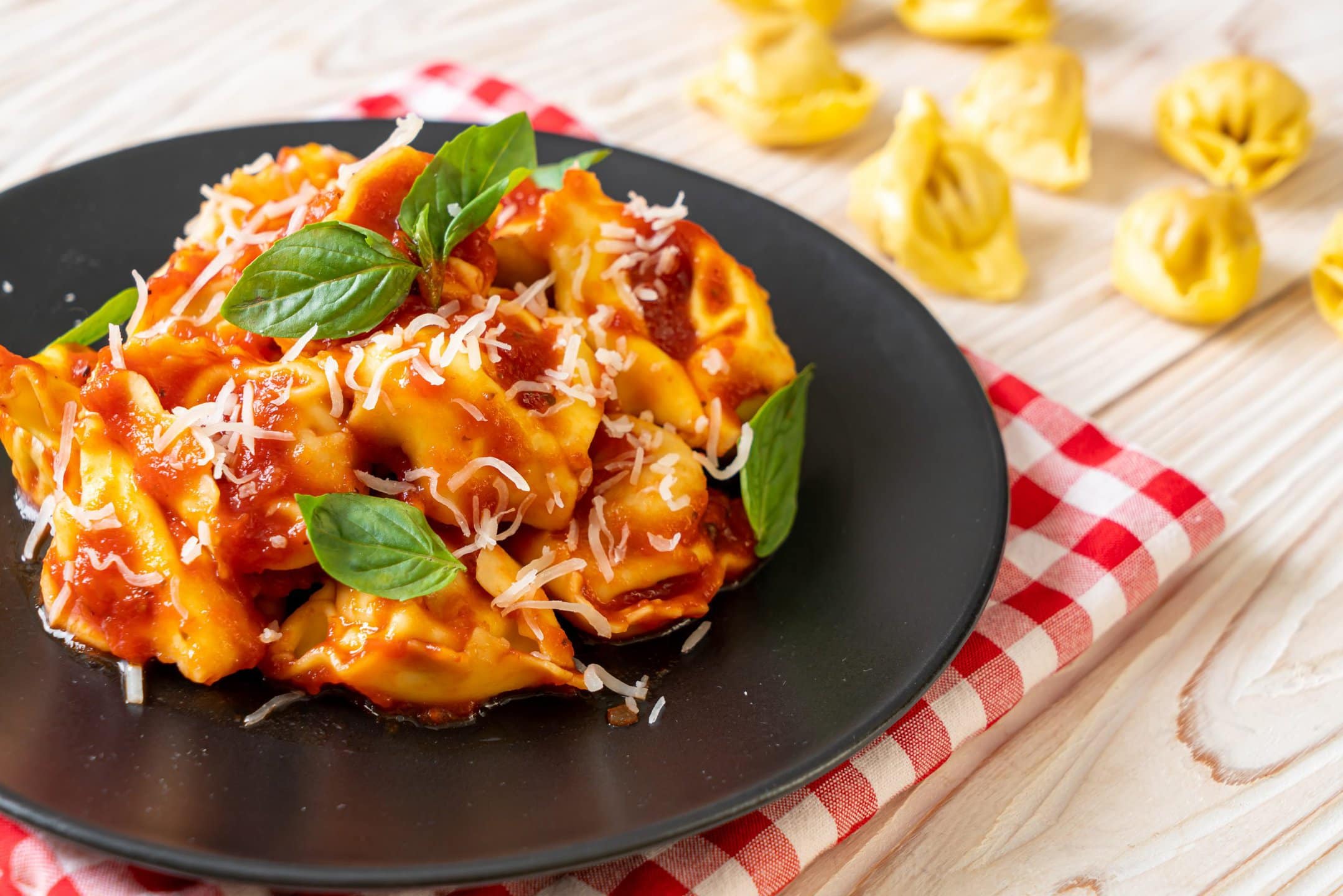 Tortellini with tomato sauce, basil, and grated cheese