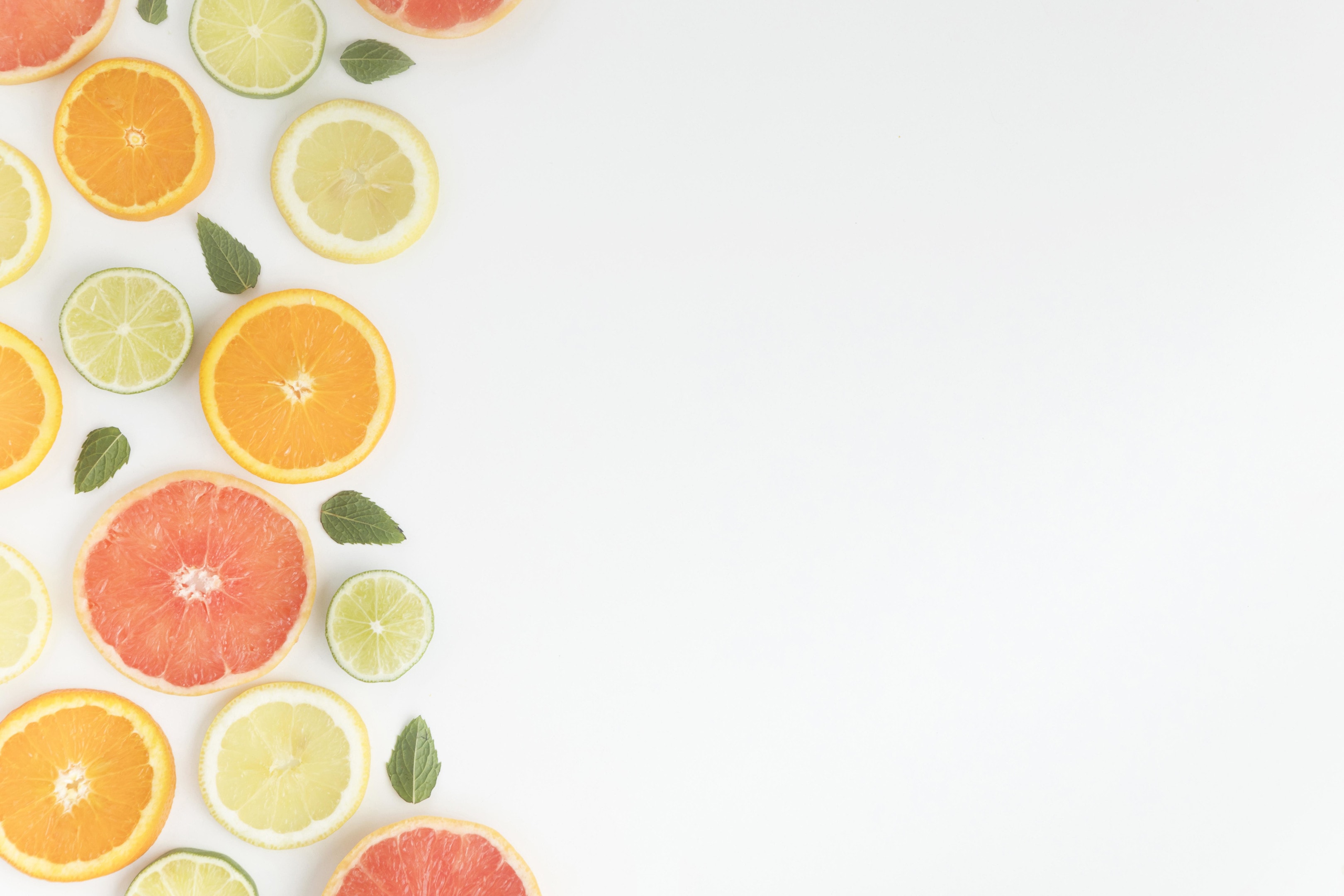 Slices of citrus fruit — limes, oranges, lemons, and grapefruits