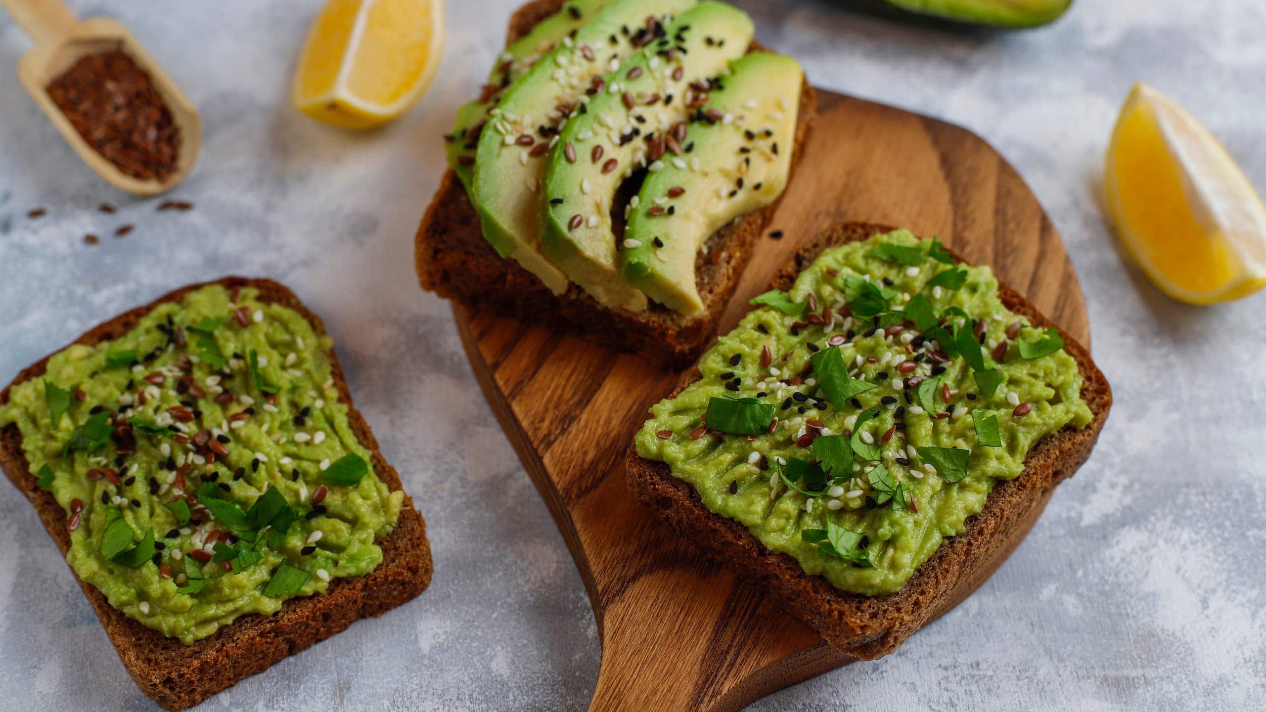 Dunkin Donuts avocado toast with avocado slices, lemon, flax seeds, and sesame seeds