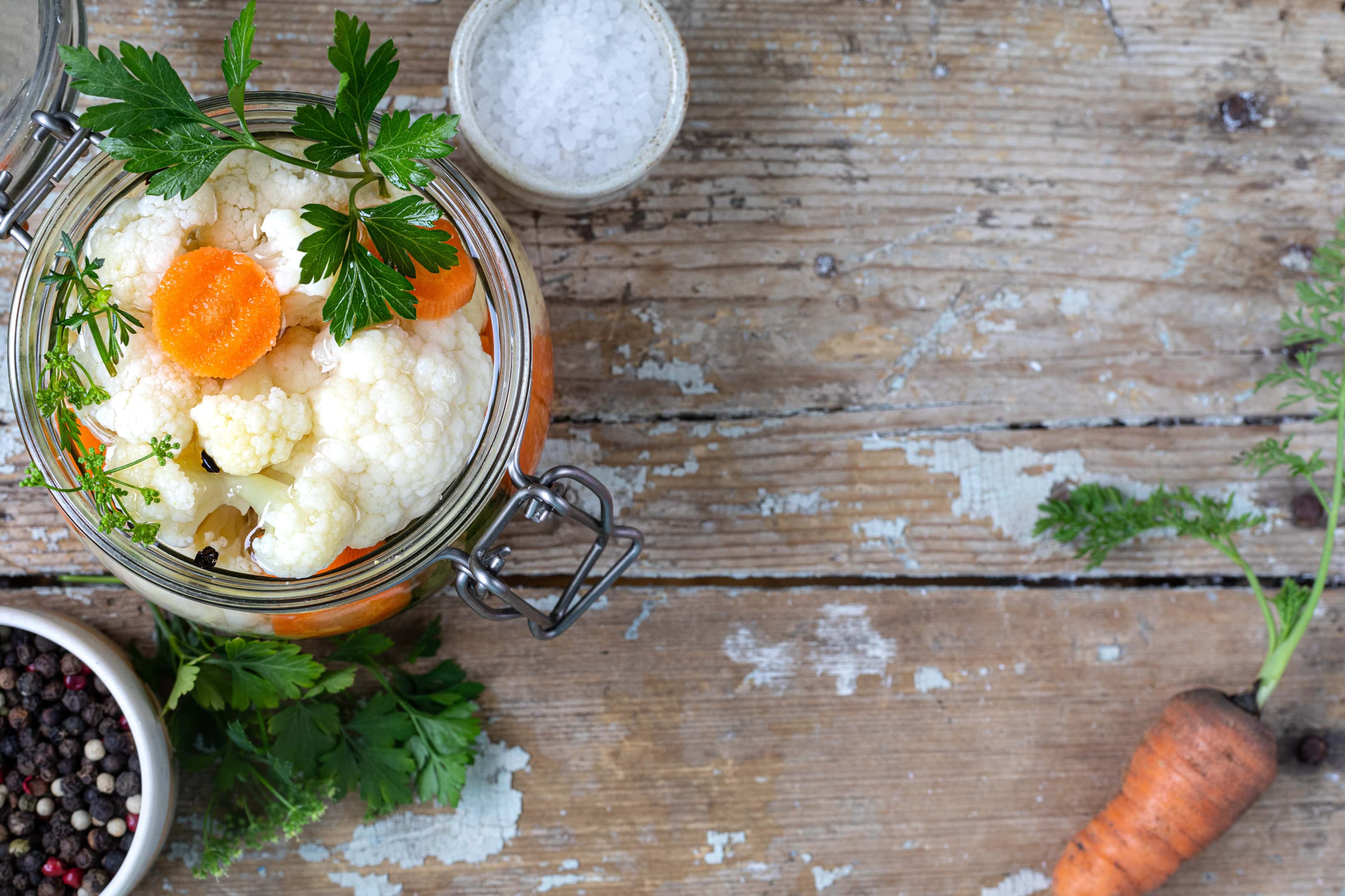 Fermented cauliflower with carrots in a glass jar