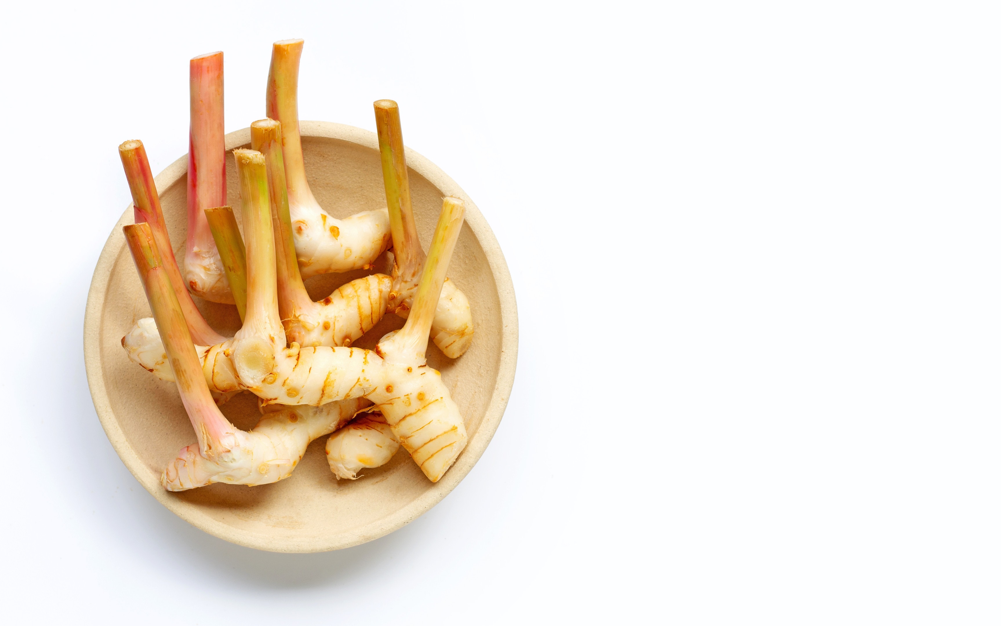 Fresh Galangal in Wooden Bowl on White Background