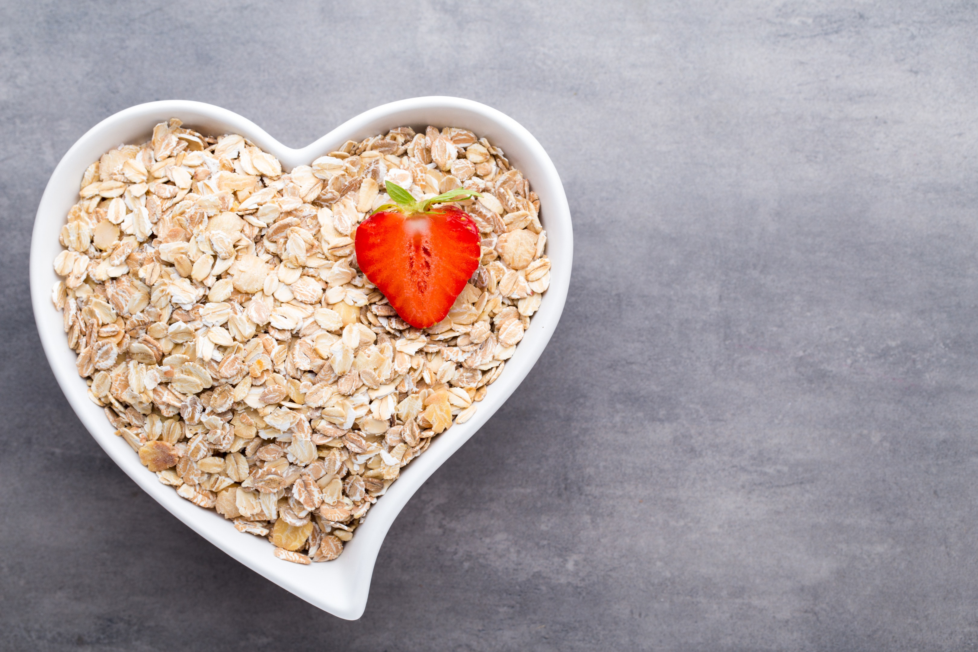 Fried oat flakes in heart shaped bowl