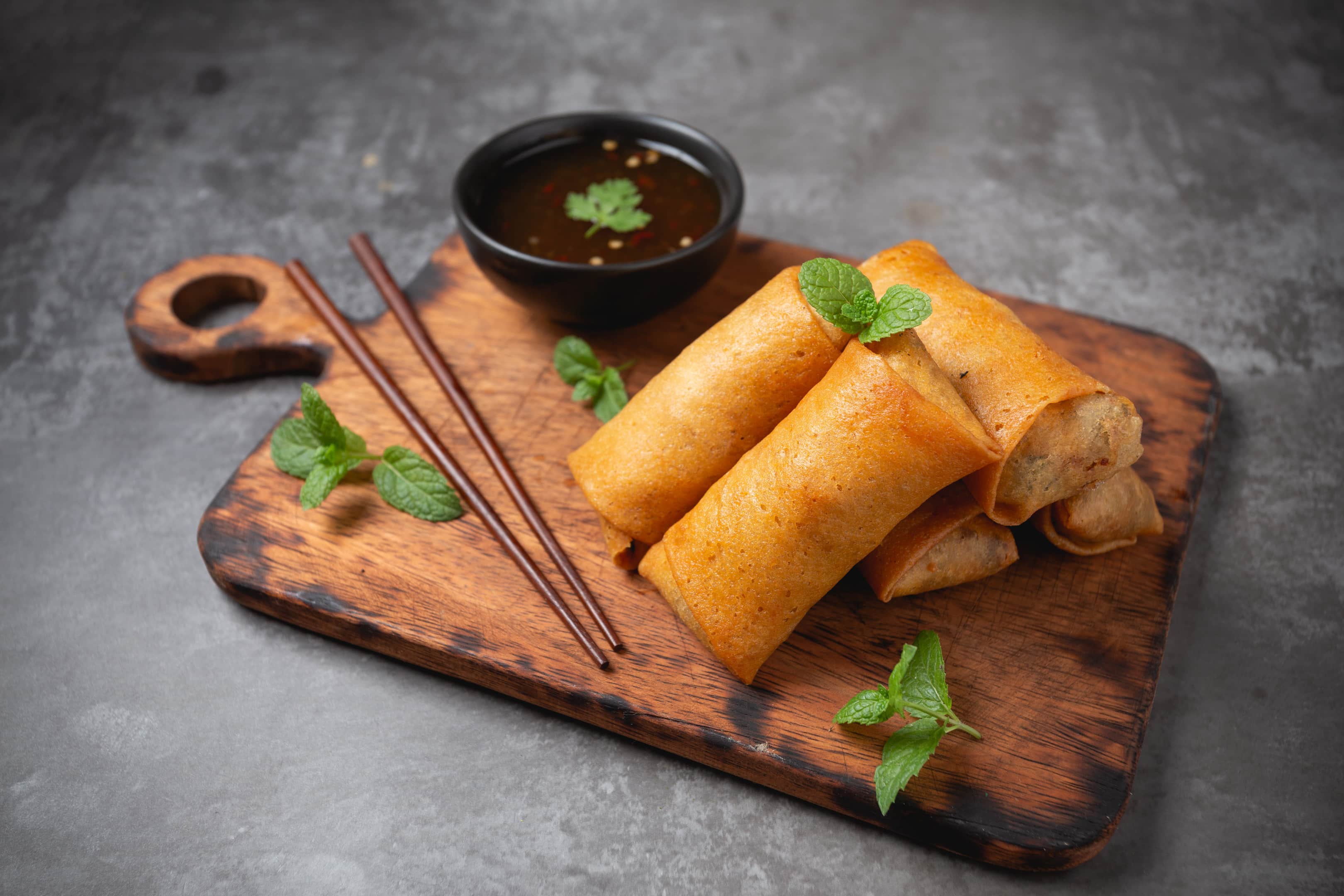 Fried spring rolls on a cutting board