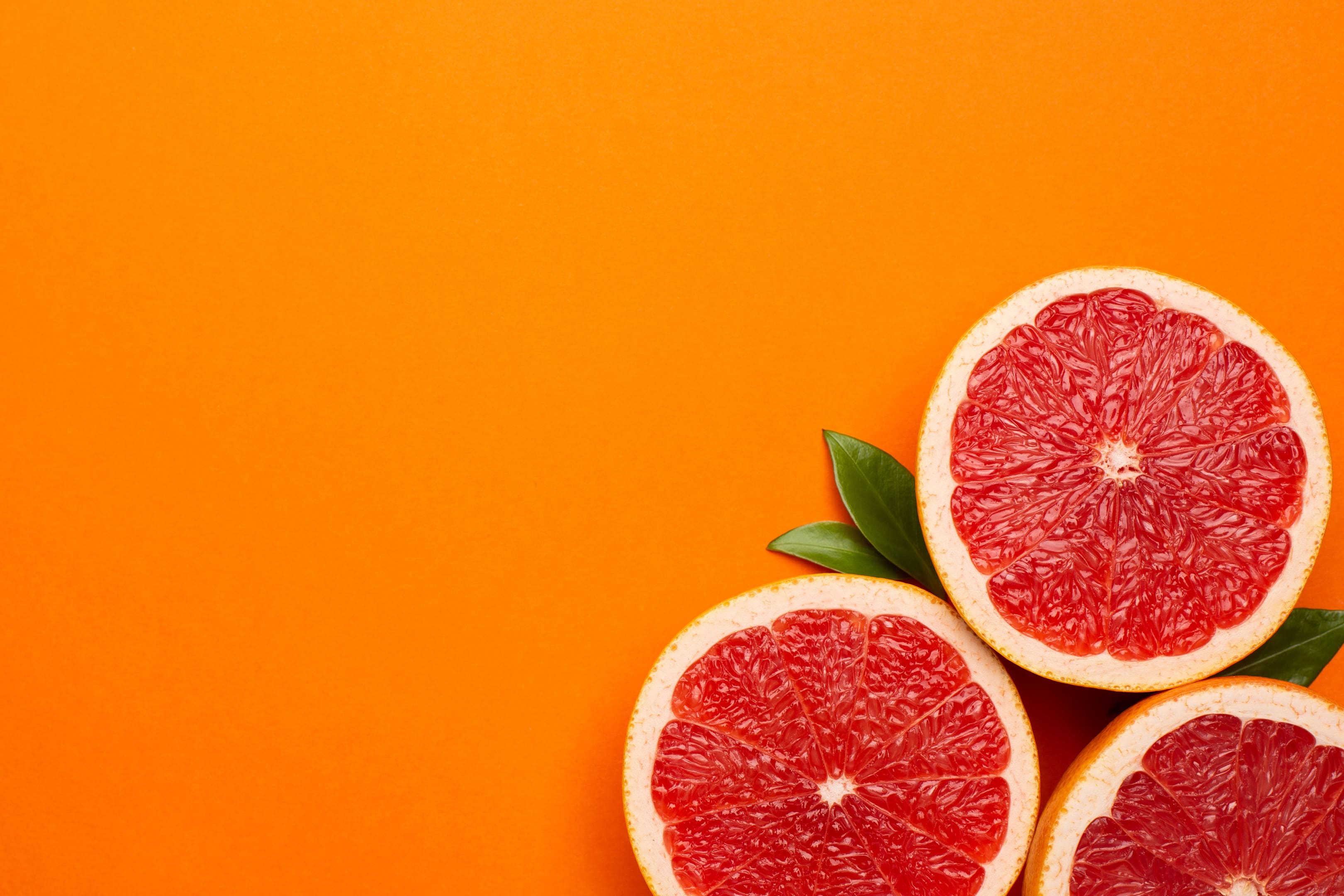 Grapefruits on orange background