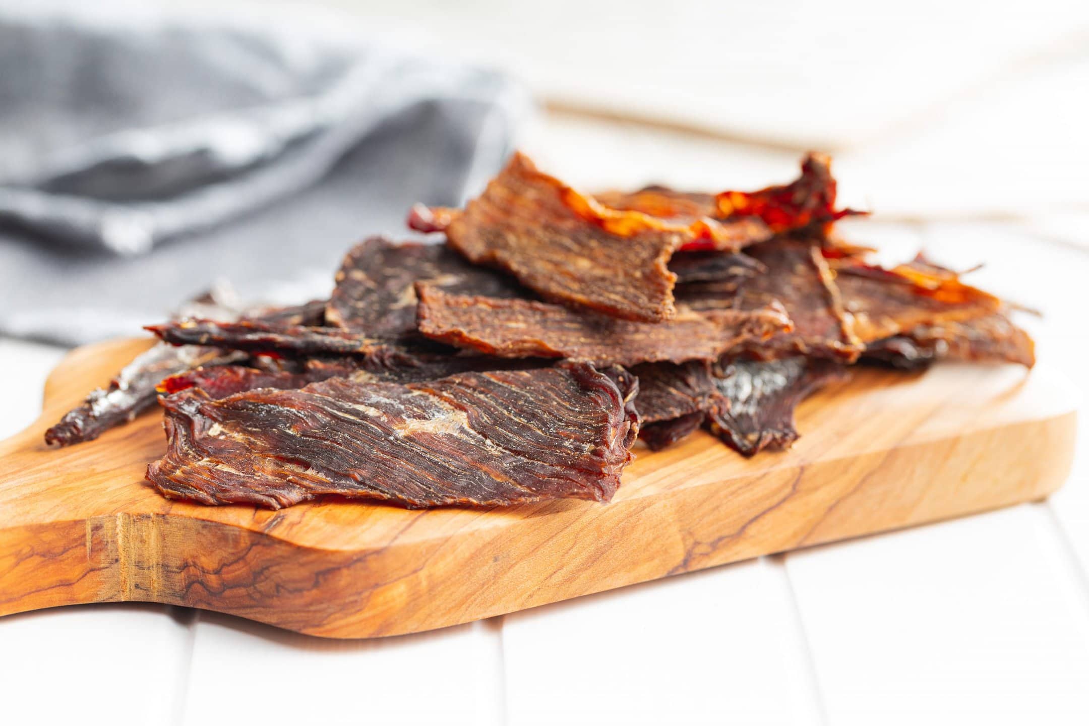 Ground deer jerky slices on a cutting board