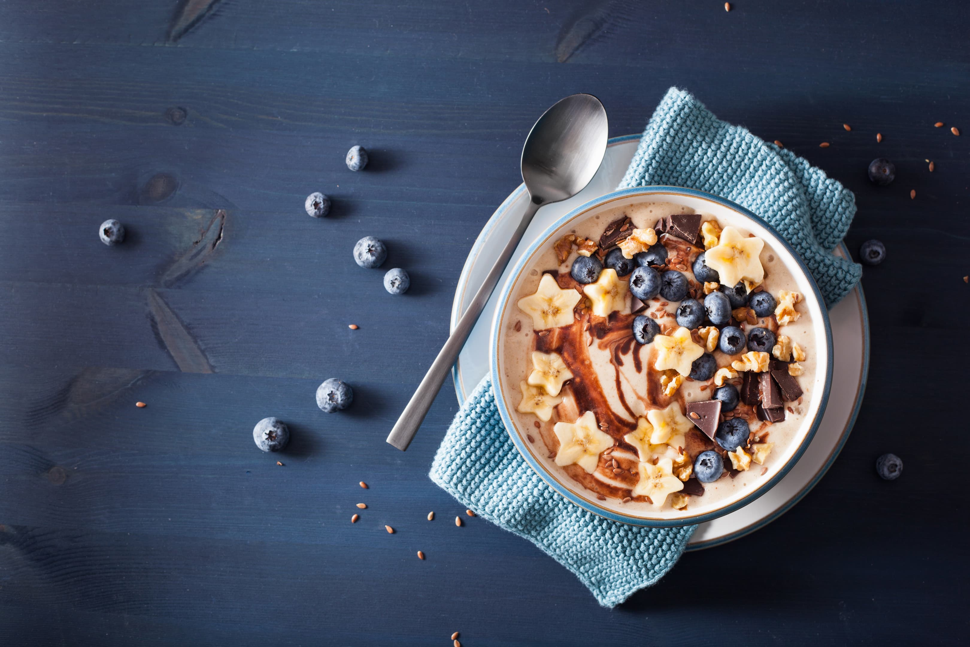 Banana smoothie bowl with blueberry, dark chocolate and walnuts