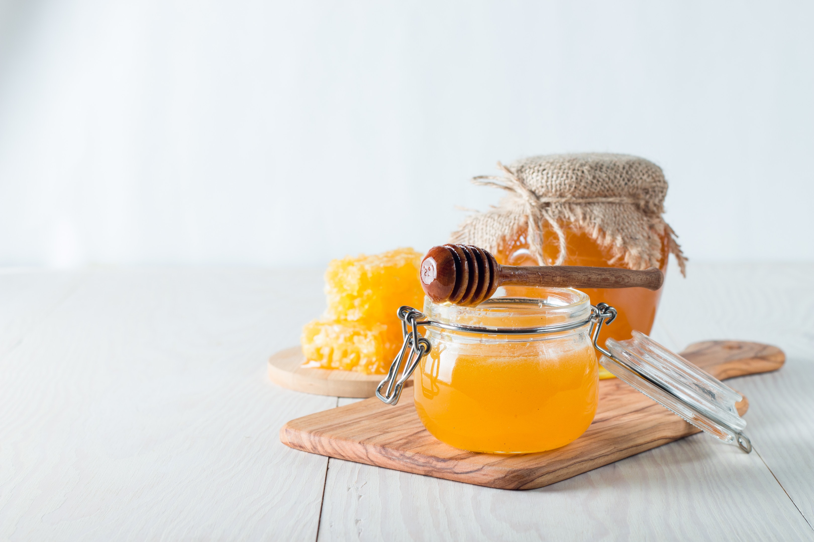 Honey jar on wooden rustic background