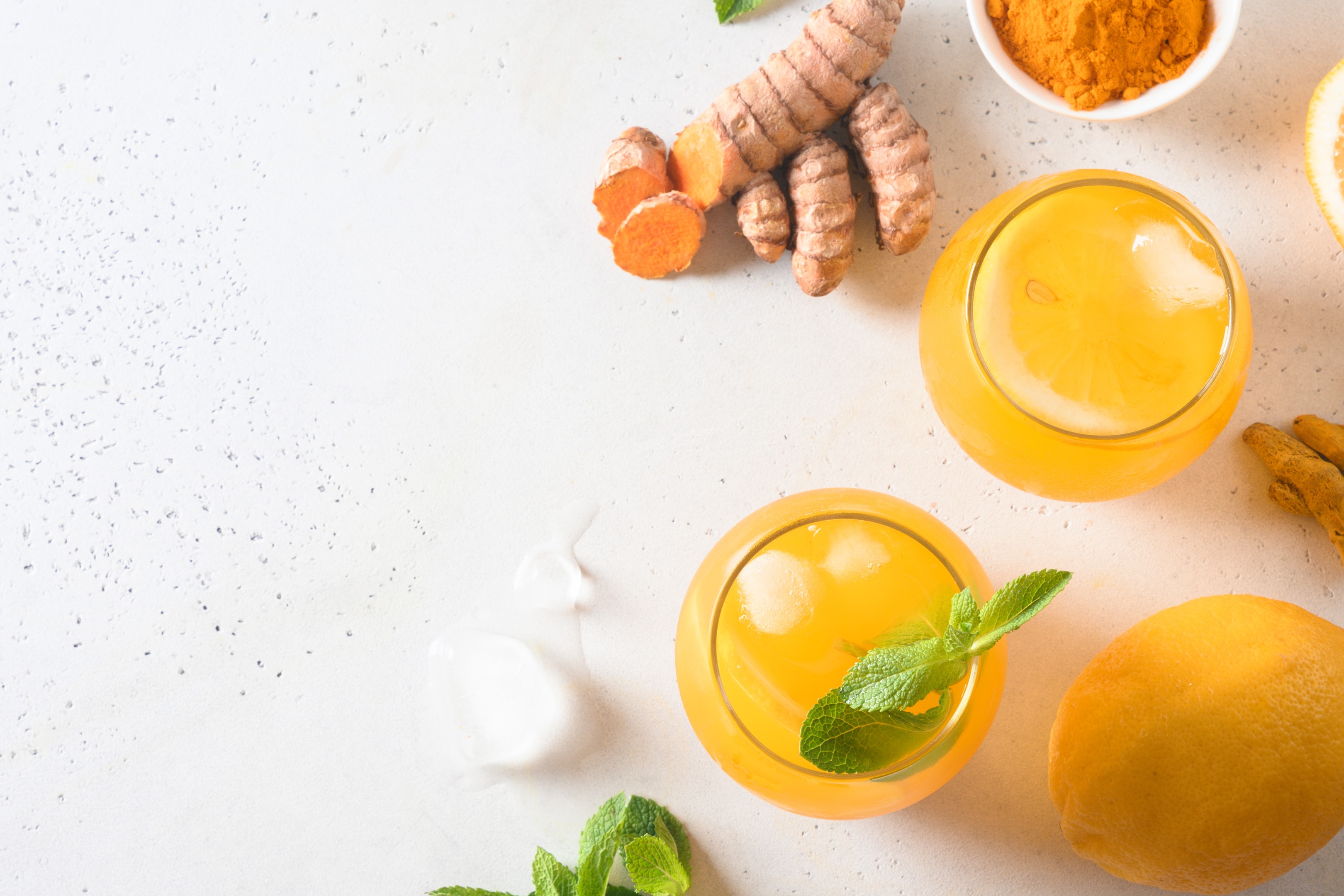 Jamu indonesian herbal beverage with natural ingredients turmeric and ginger on white table