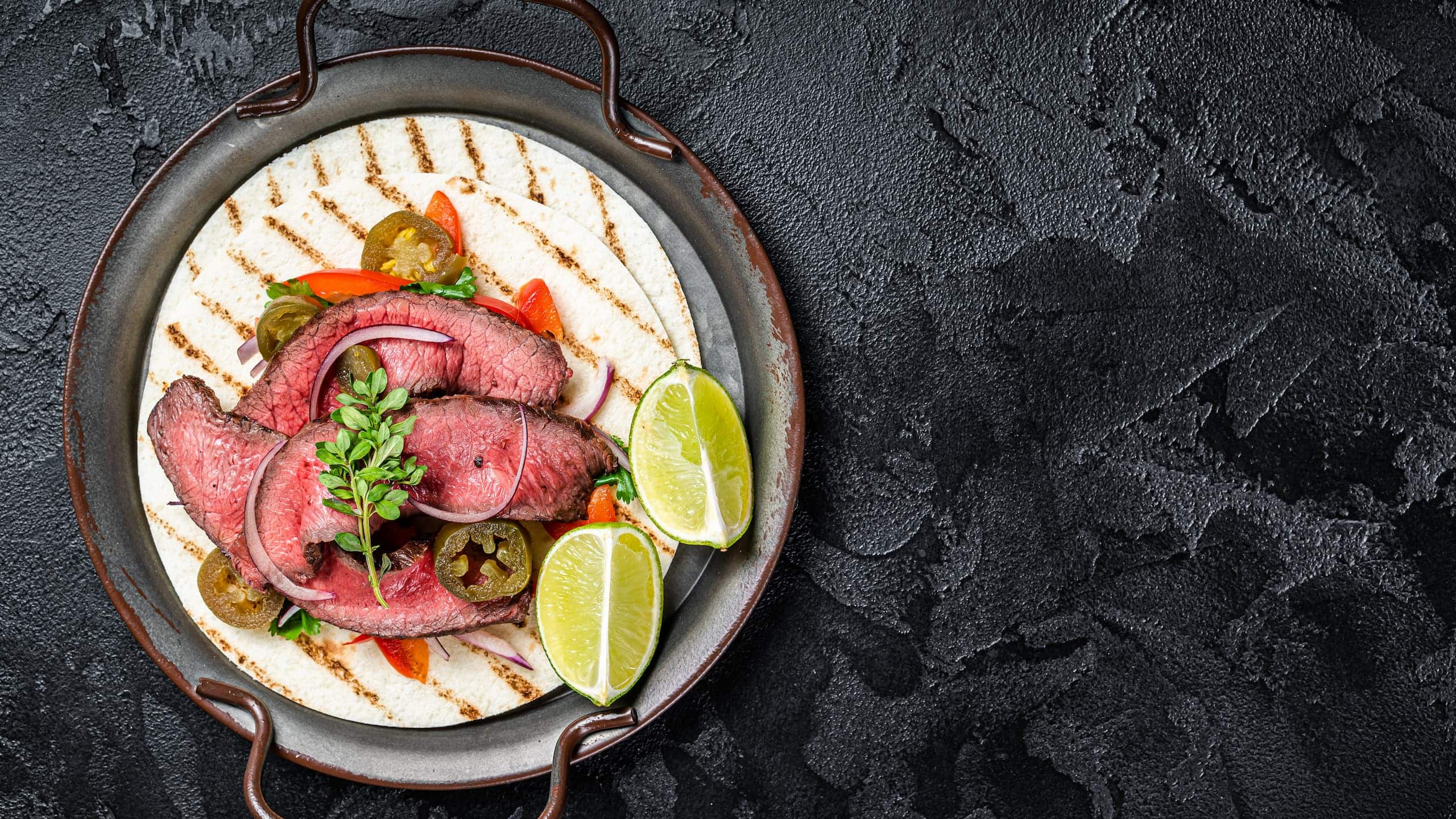 Lupe Tortilla fajita with grilled steak, jalapenos, and onion