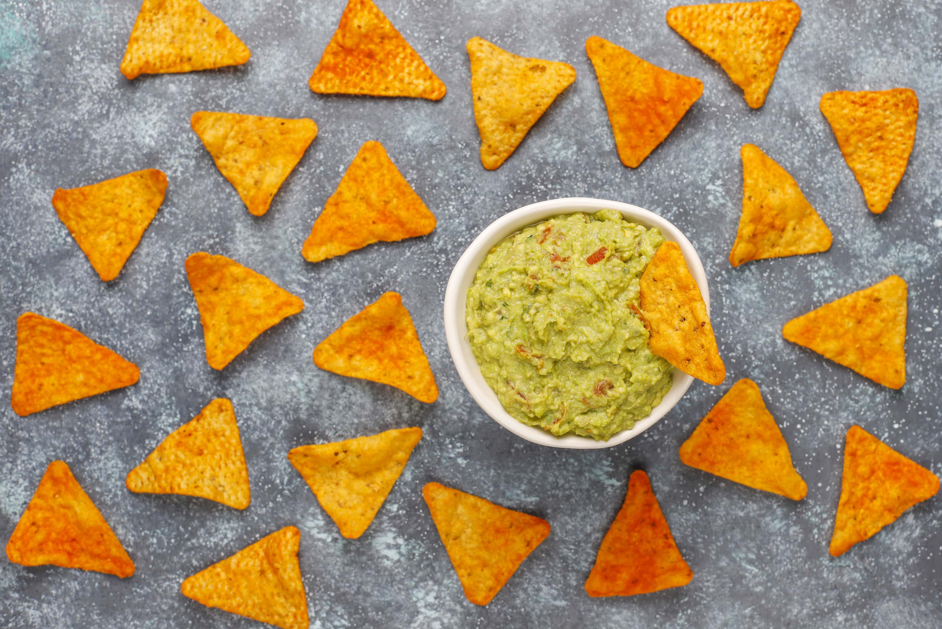 Plain tortilla chips with homemade hot guacamole sauce