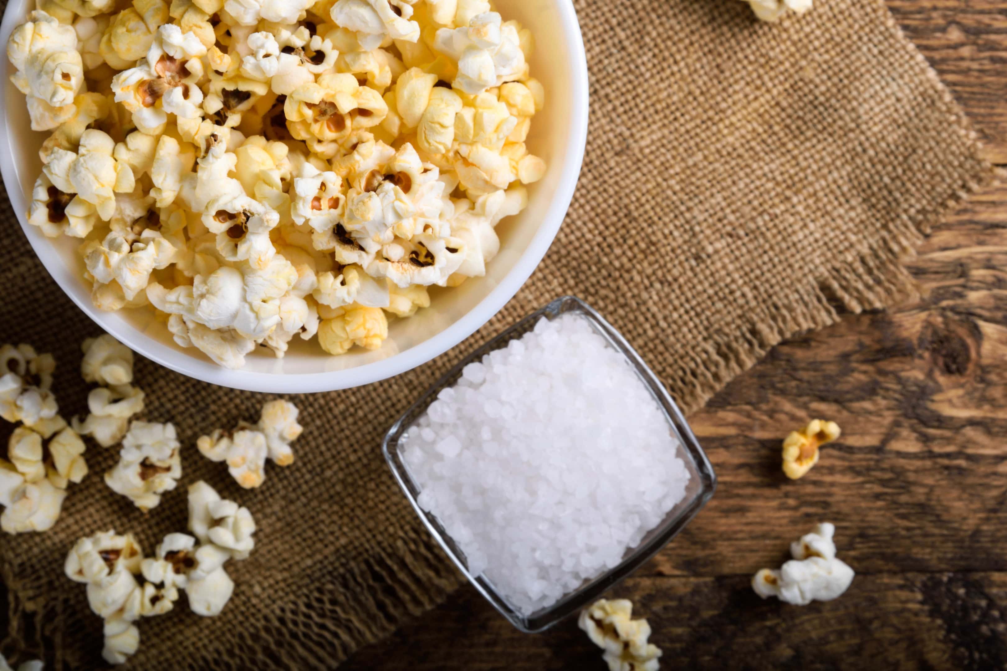 Popcorn bowl with salt bowl on wooden table