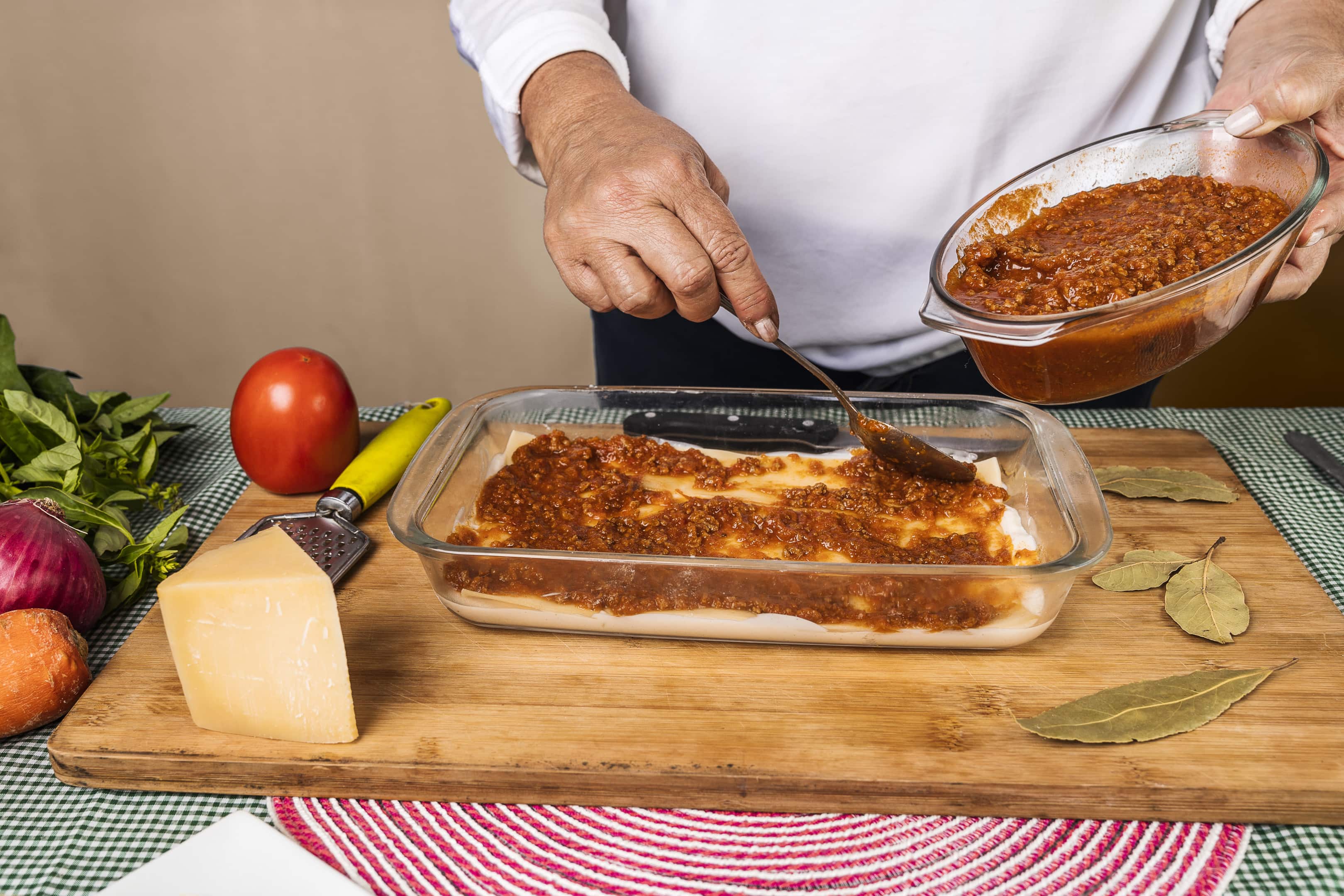 Spreading Bolognese sauce on the San Giorgio lasagna