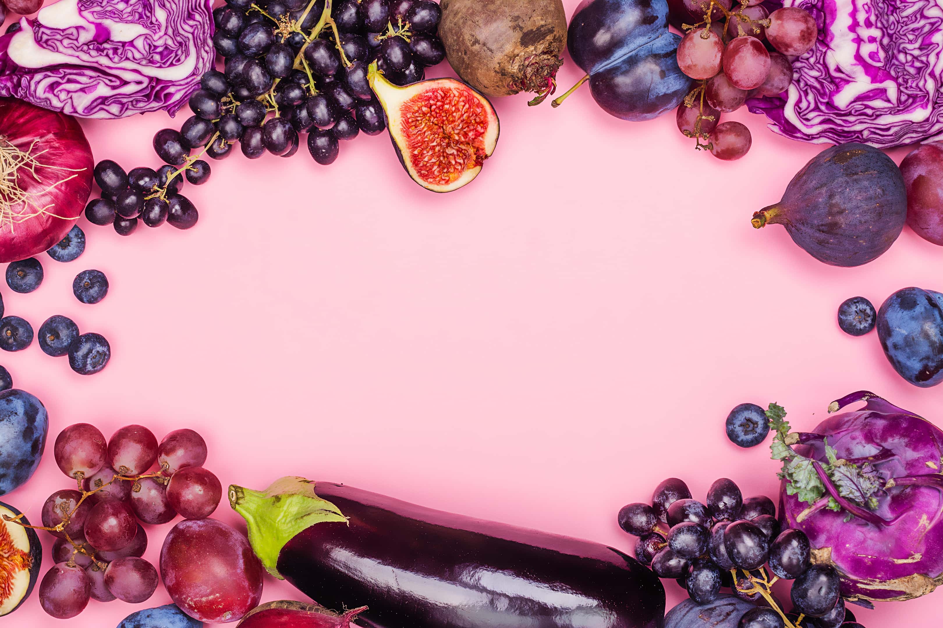 Selection of purple fruit grapes plums blueberries and figs