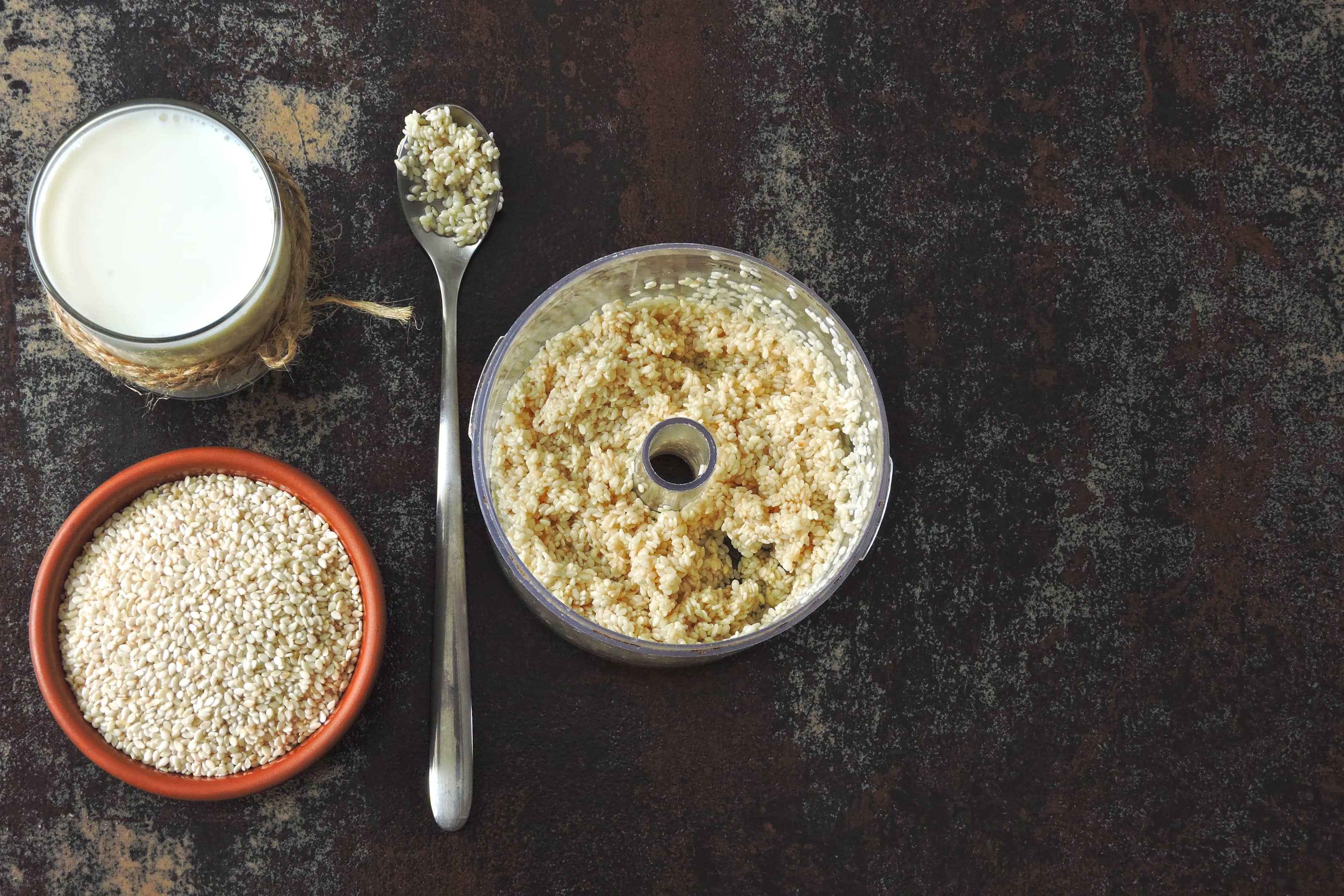 Sesame milk and sesame seeds in food processor chamber