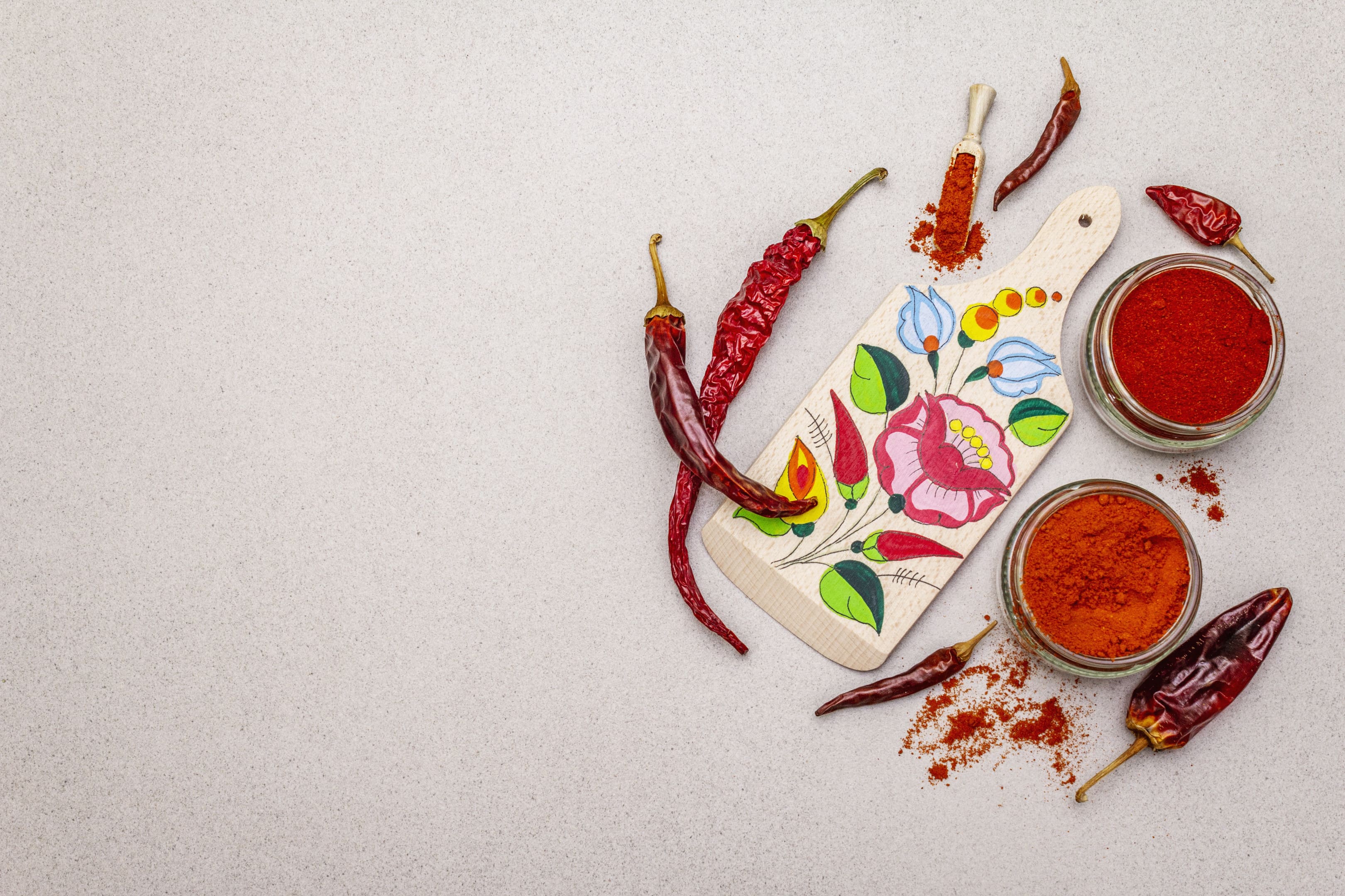 Sweet and hot hungarian paprika powder and cutting board