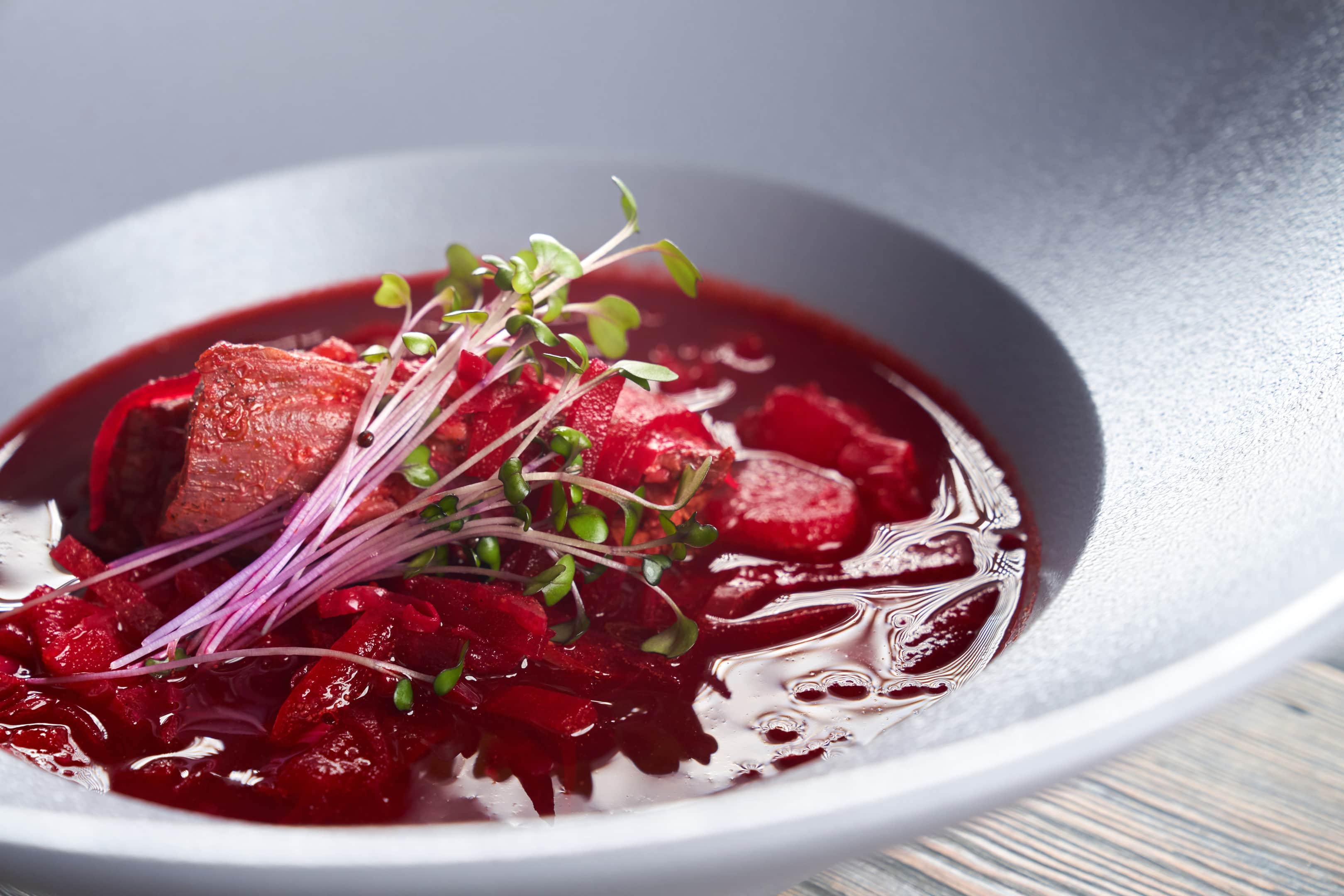 Traditional ukrainian beet soup with meat, vegetables and a splash of gin