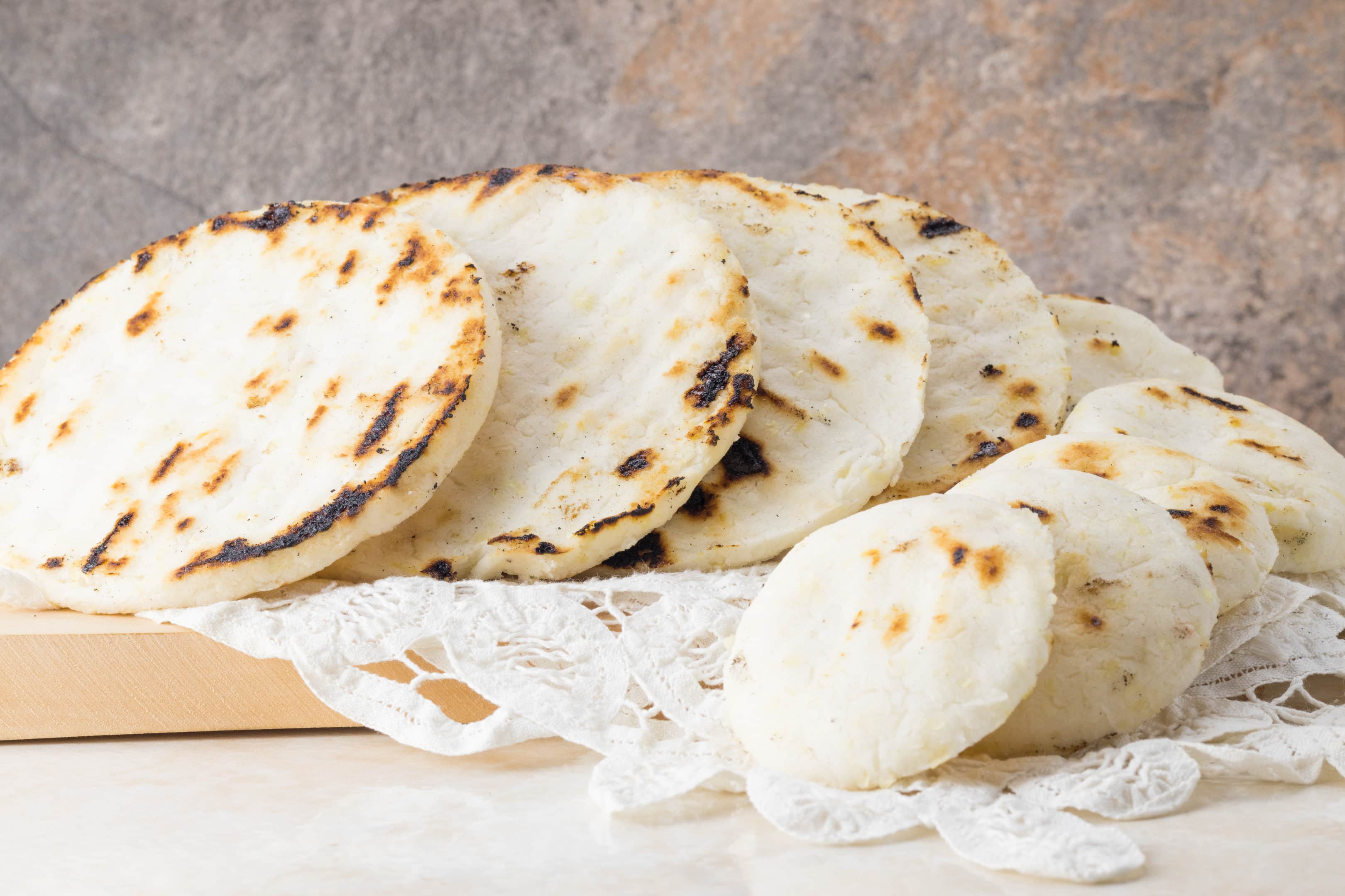 Tasty arepas con queso in different sizes