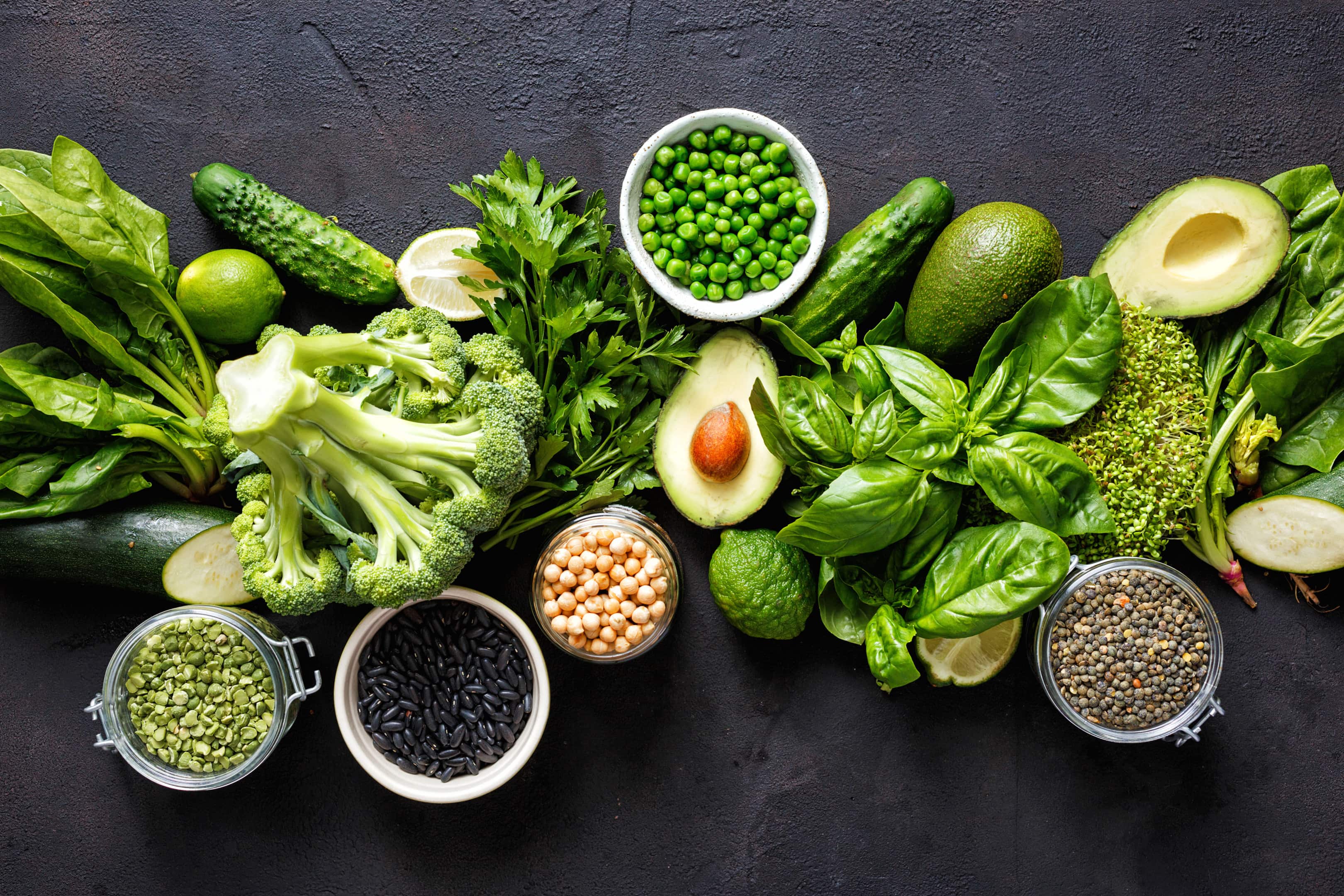 Various leafy green vegetables on dark background