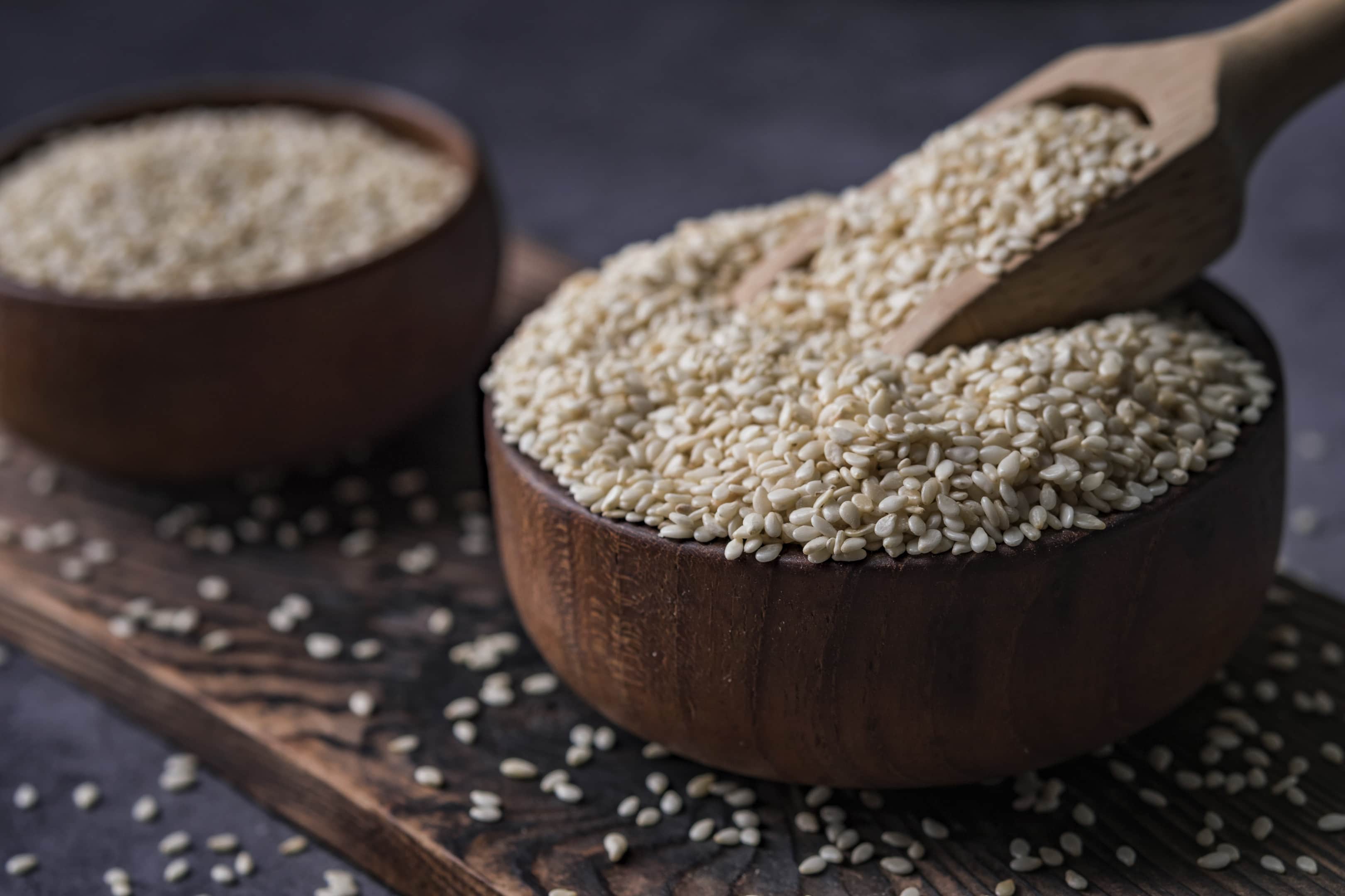 White Sesame in Wooden Bowl on Dark Table