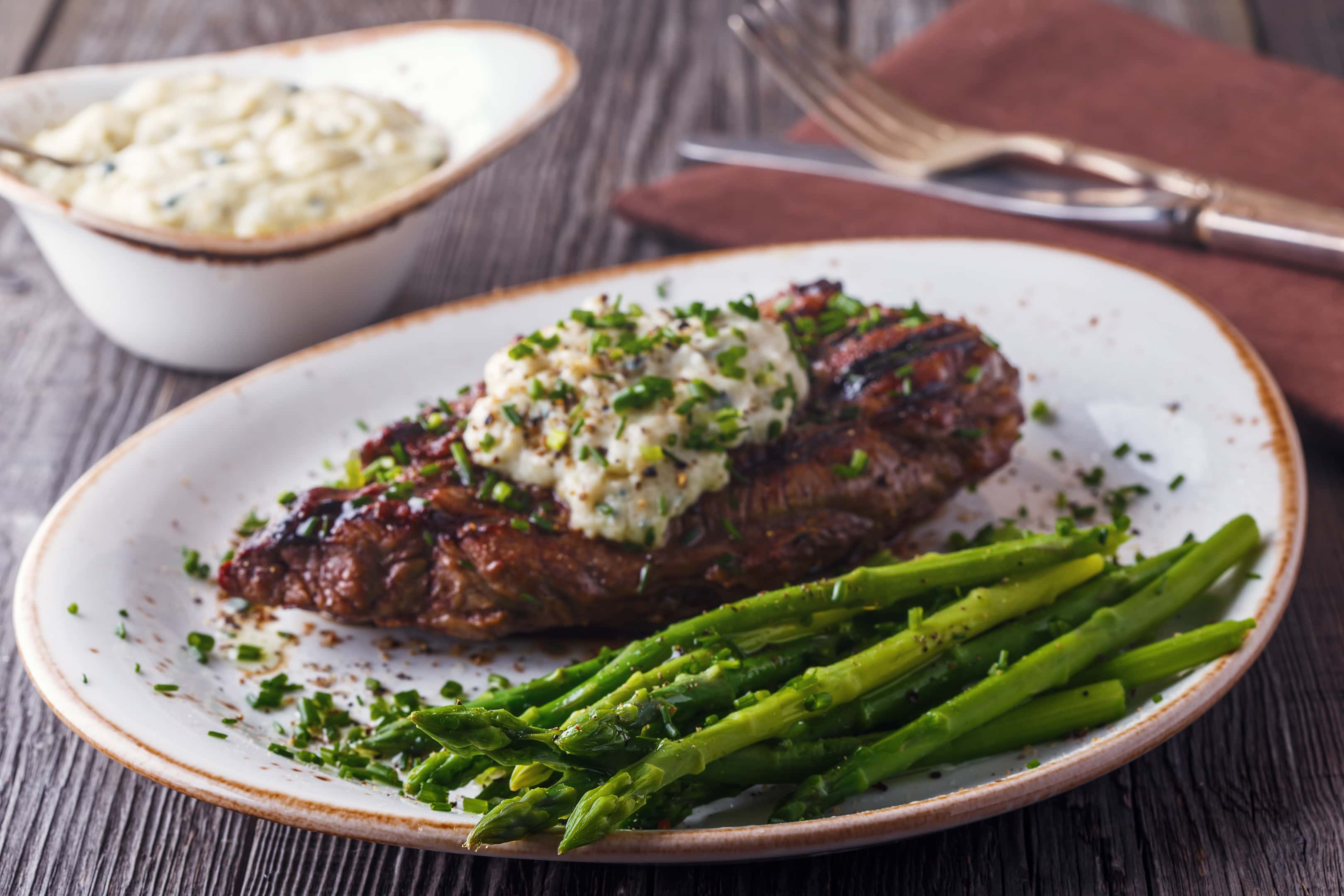<a href="https://blend-of-bites.ghost.io/25-foods-that-starts-with-x/" target="_blank" rel="noreferrer noopener">Xavier steak</a> with cheese sauce served with asparagus