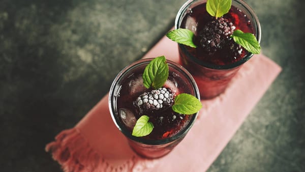 Homemade blackberry moonshine garnished with mint