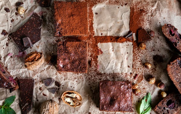 Homemade chocolate chickpea brownie vegan and gluten-free on a paper with nuts