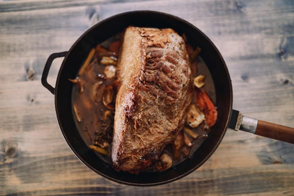 Pan-roasted beef in a skillet with vegetables