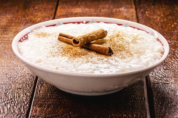 Sweet rice pudding with cooked rice and cinnamon stick