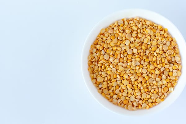 Yellow split peas in a white bowl