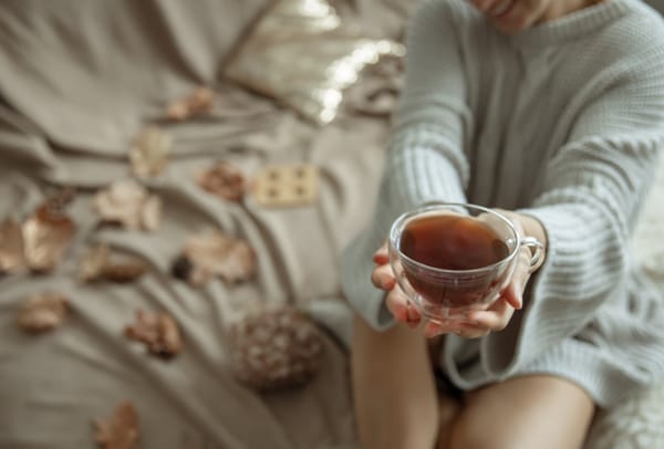 A woman holding a warm cup of tea.