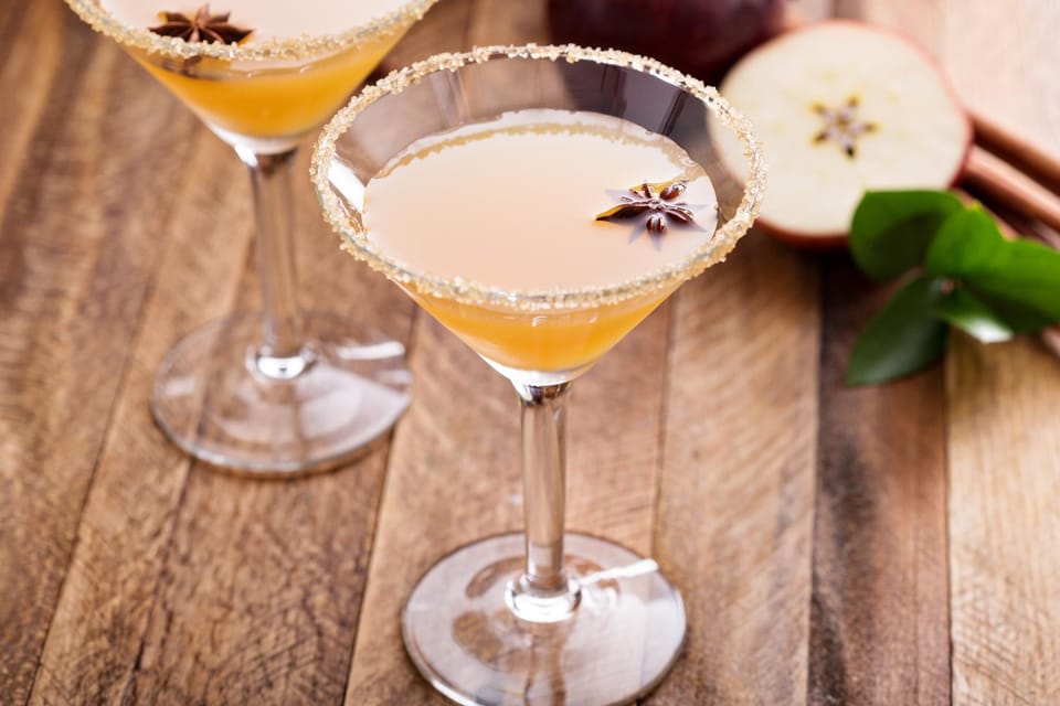 Apple cider martini in a sugar-rimmed glass with star anise