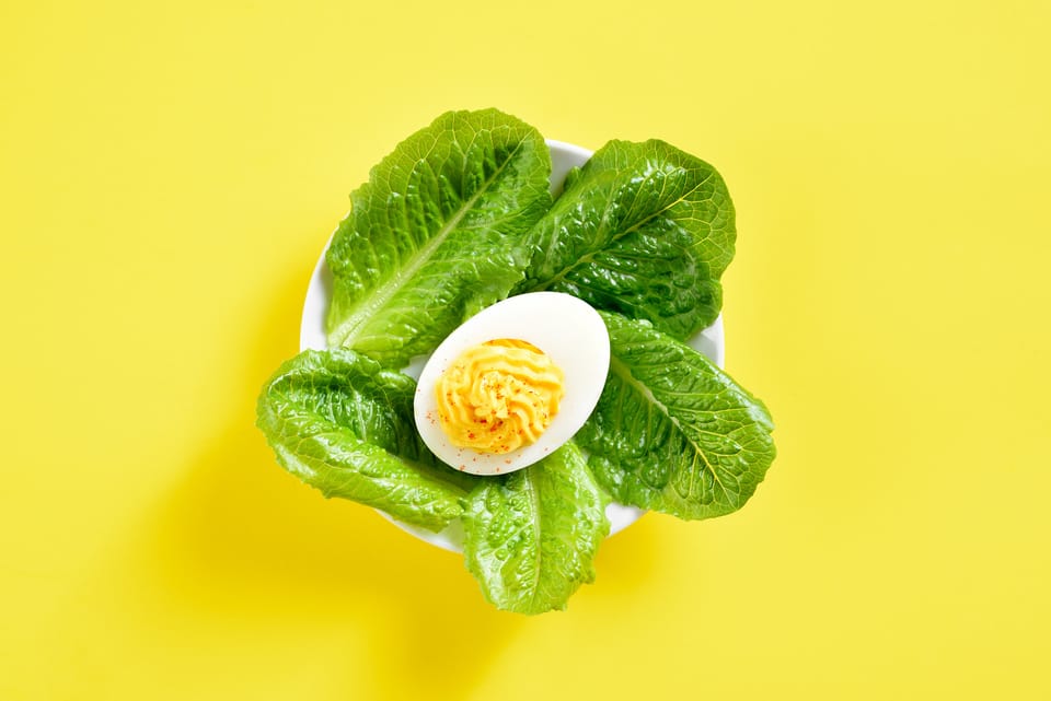 Deviled egg on vegetable leaves