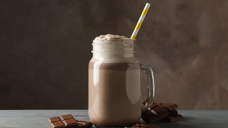 A glass of Herbalife Shake with chocolate bars