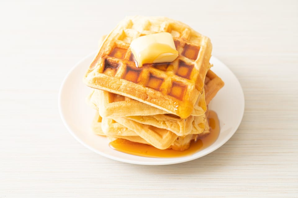 Homemade Aunt Jemima waffle with butter and honey maple syrup