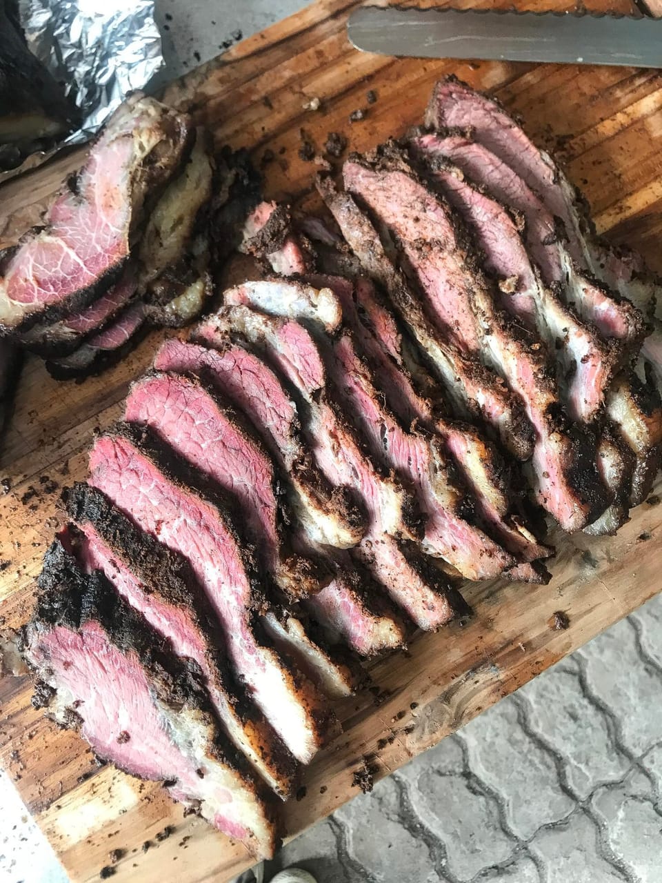 Sliced smoked brisket on a wooden board