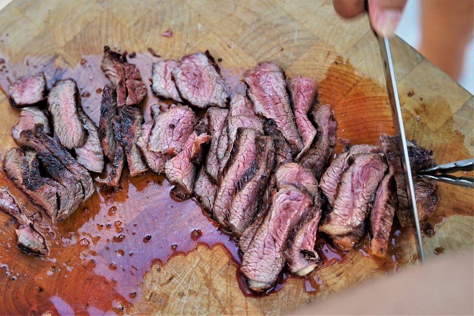 Sliced brisket on a wooden cutting board