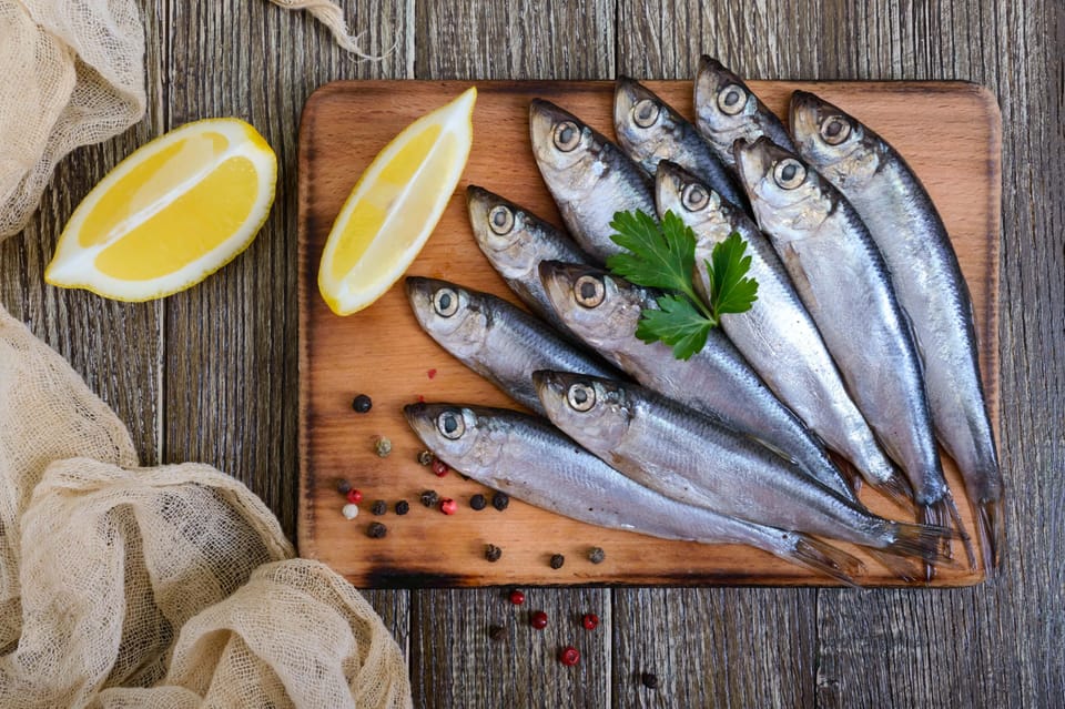 Sardines on wooden board