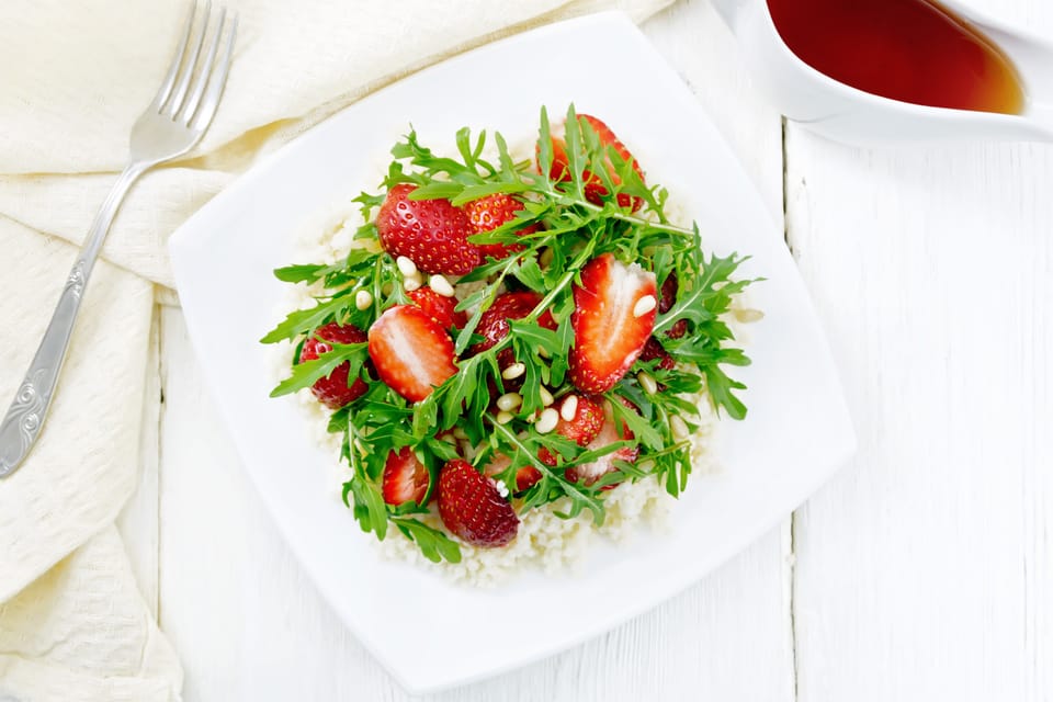 Strawberry couscous and arugula salad dressed with dry sherry
