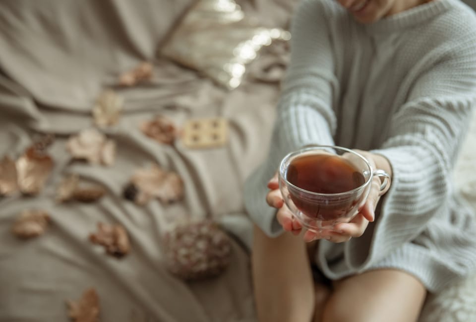 A woman holding a warm cup of tea.