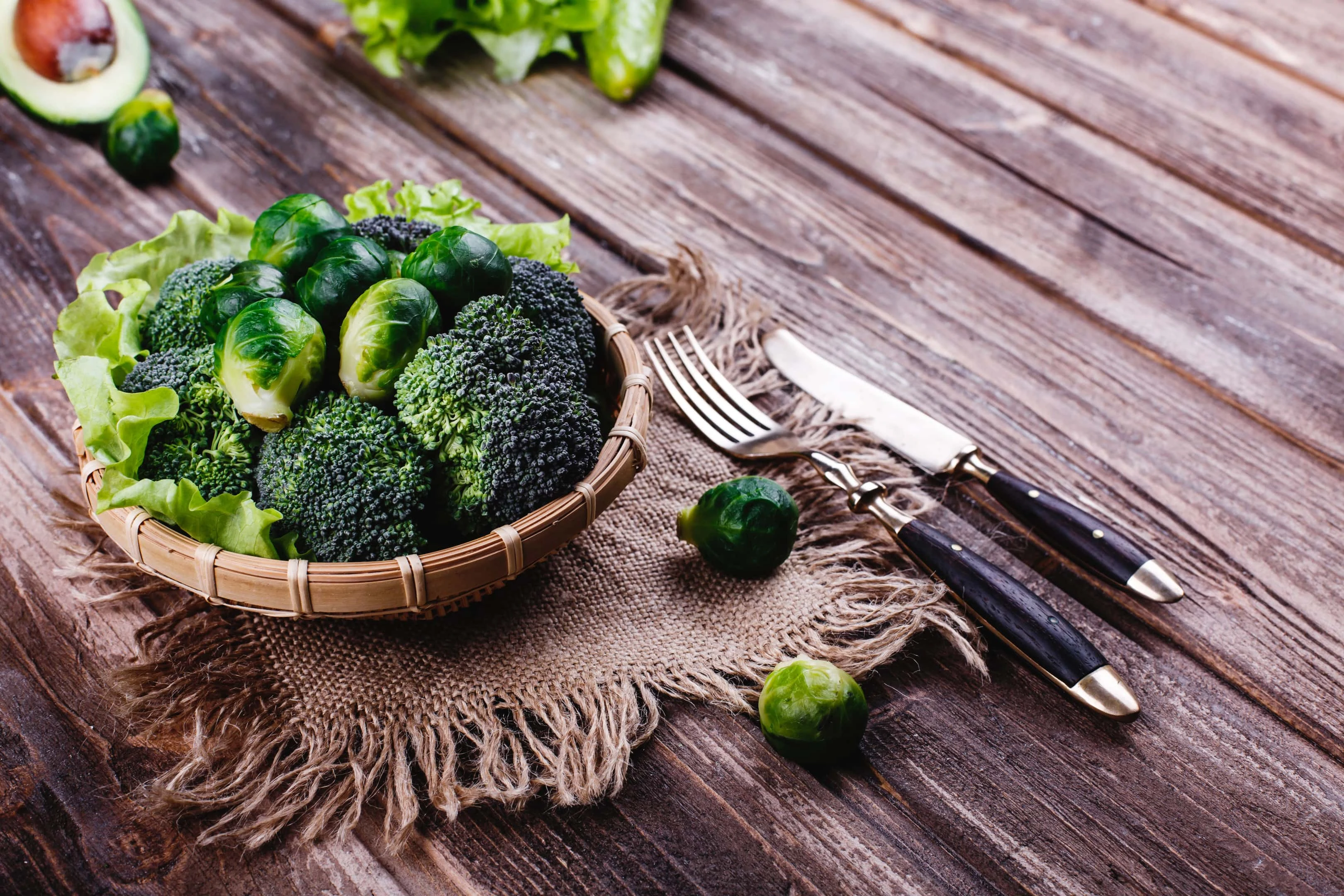 Wooden bowl with broccoli and brussel sprou