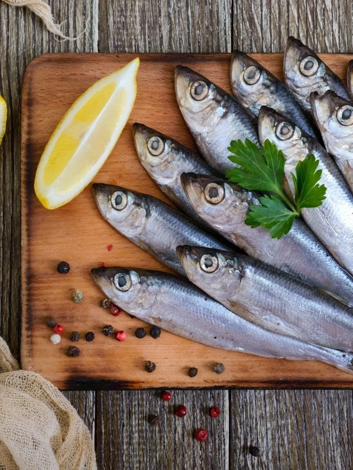 Sardines on wooden board