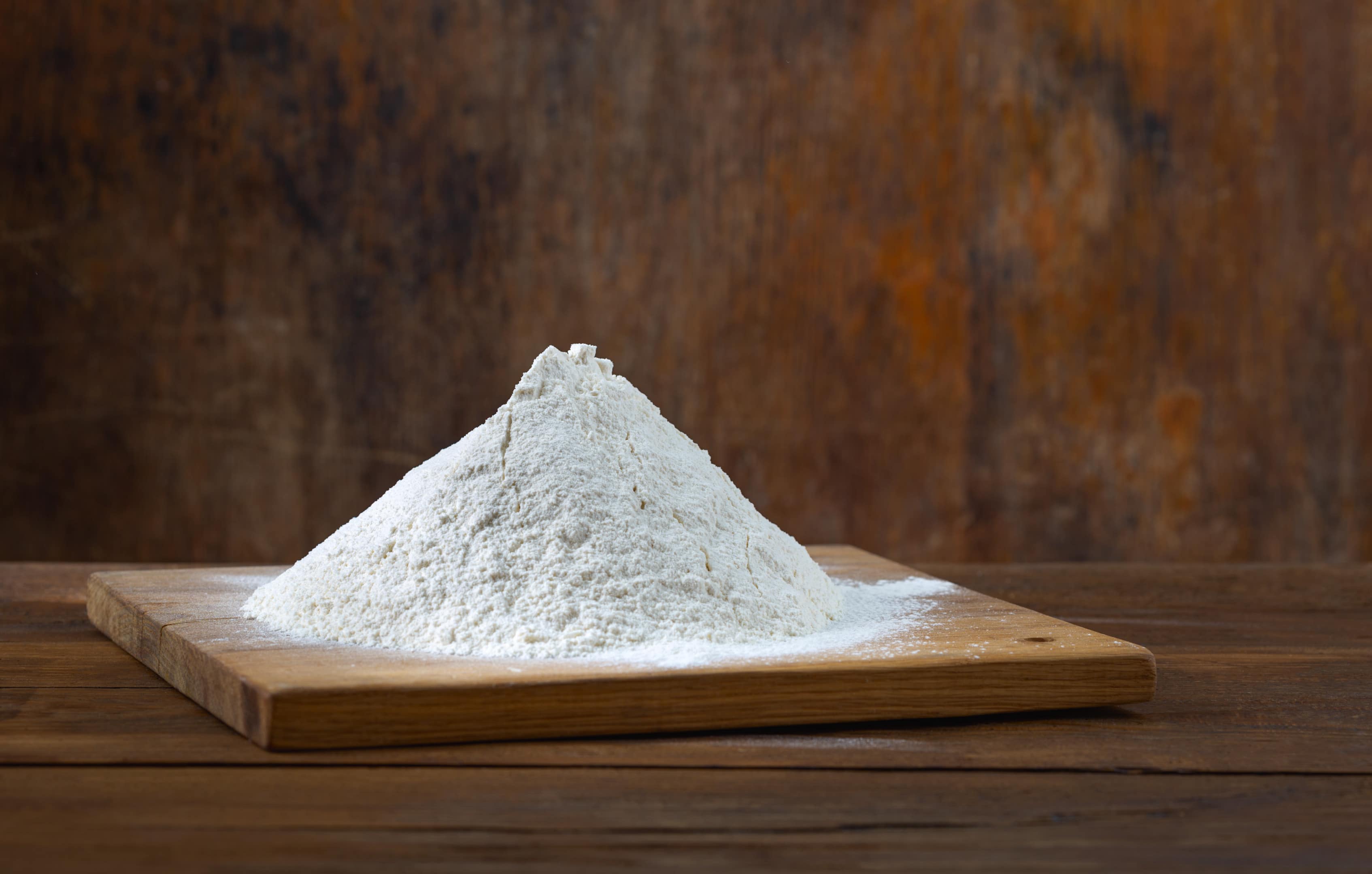 All-purpose flour on wooden board