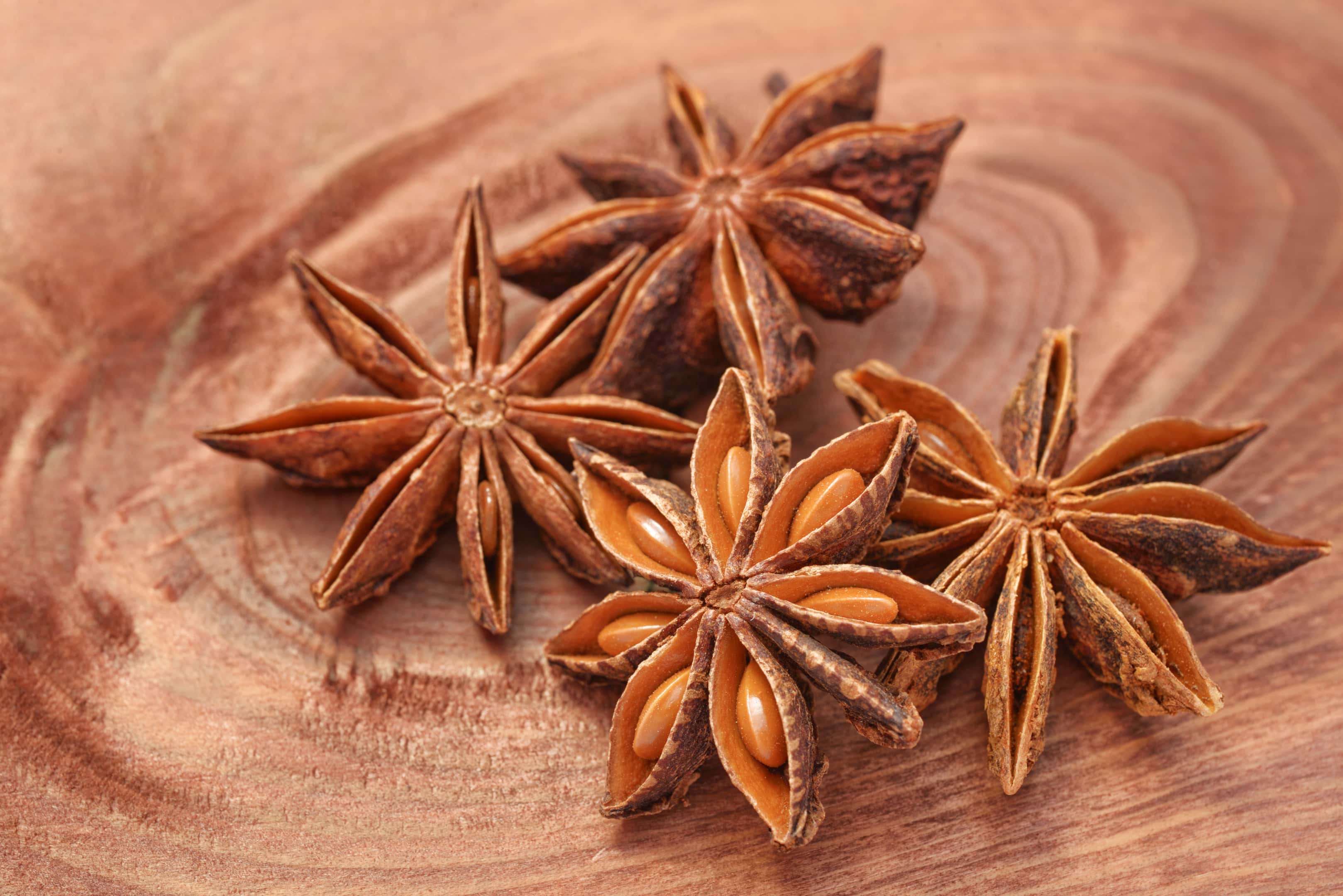 Anise star with anise seeds on wood