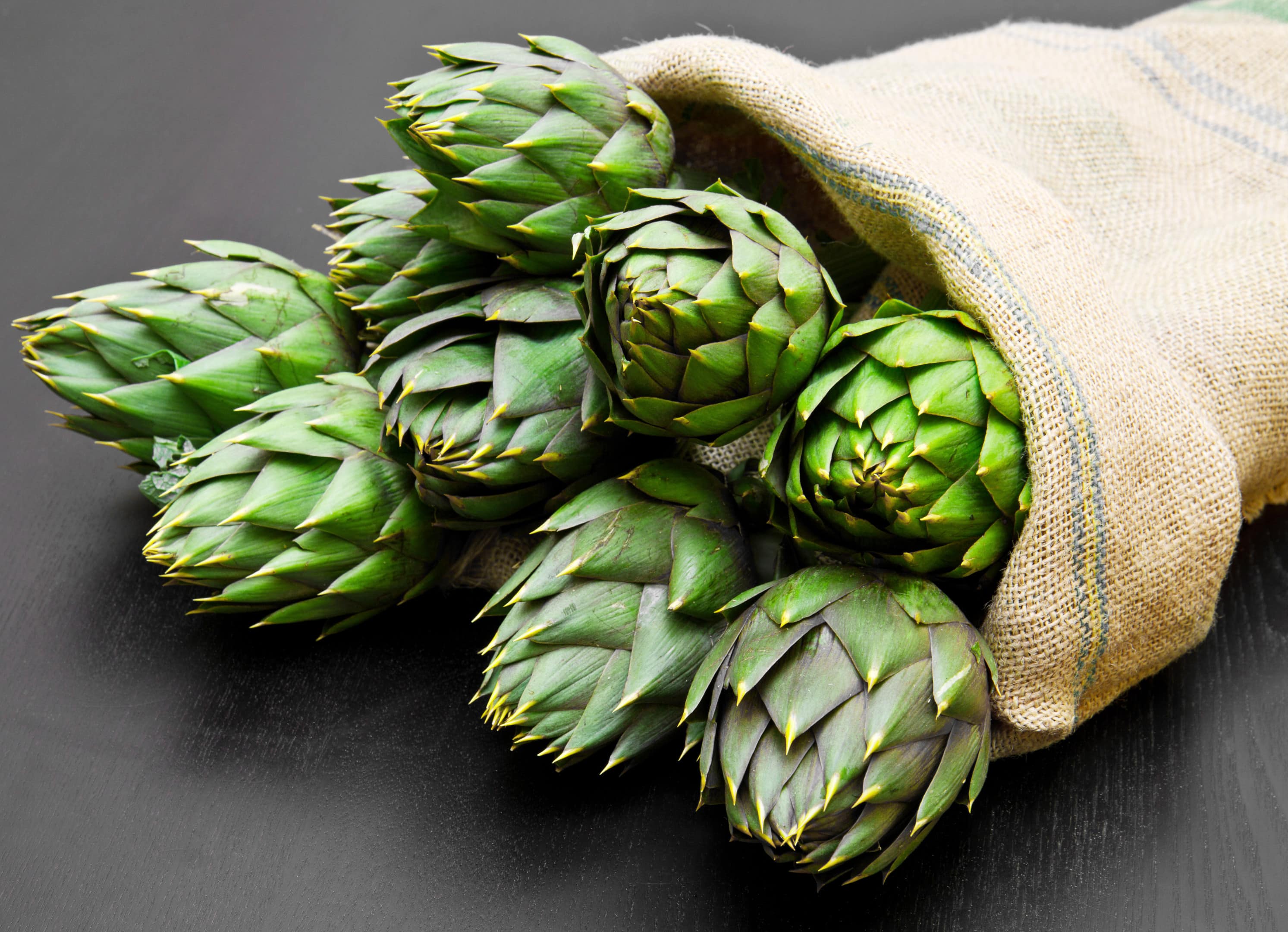 Artichoke in burlap in wood sack