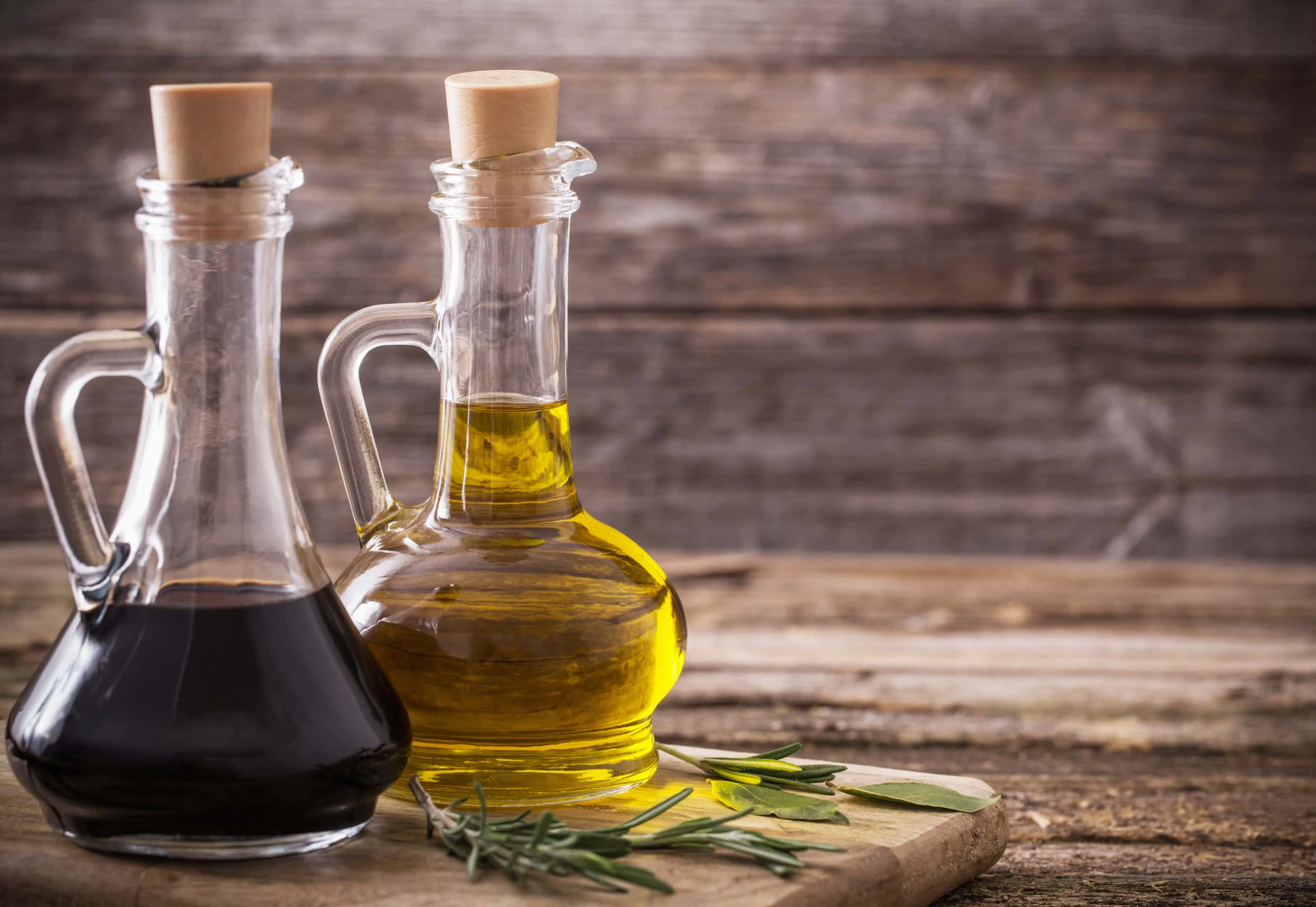 Balsamic vinegar and olive oil on wooden table