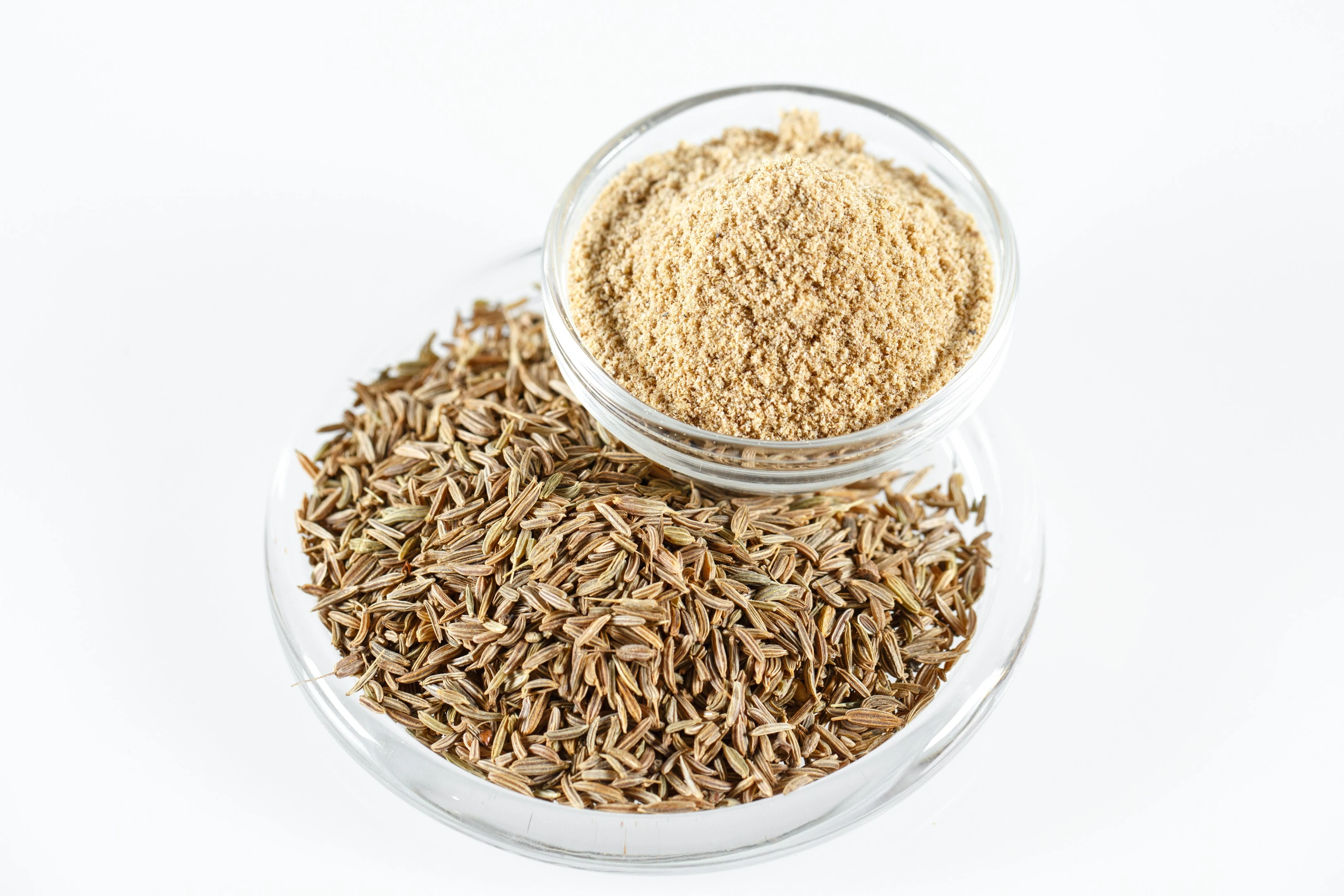 Cumin seeds and ground cumin in bowls
