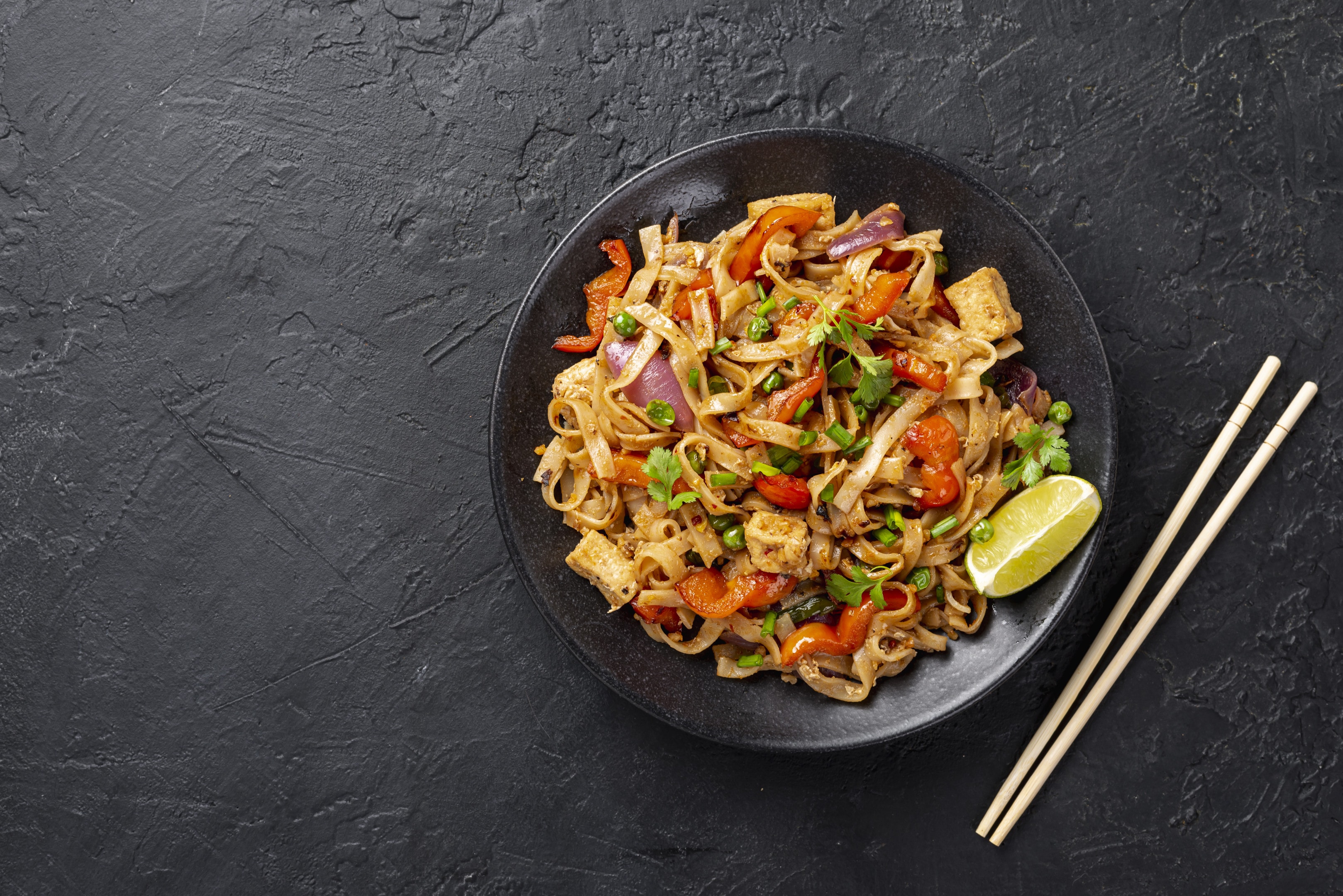Flat lay asian noodles with vegetables and chicken