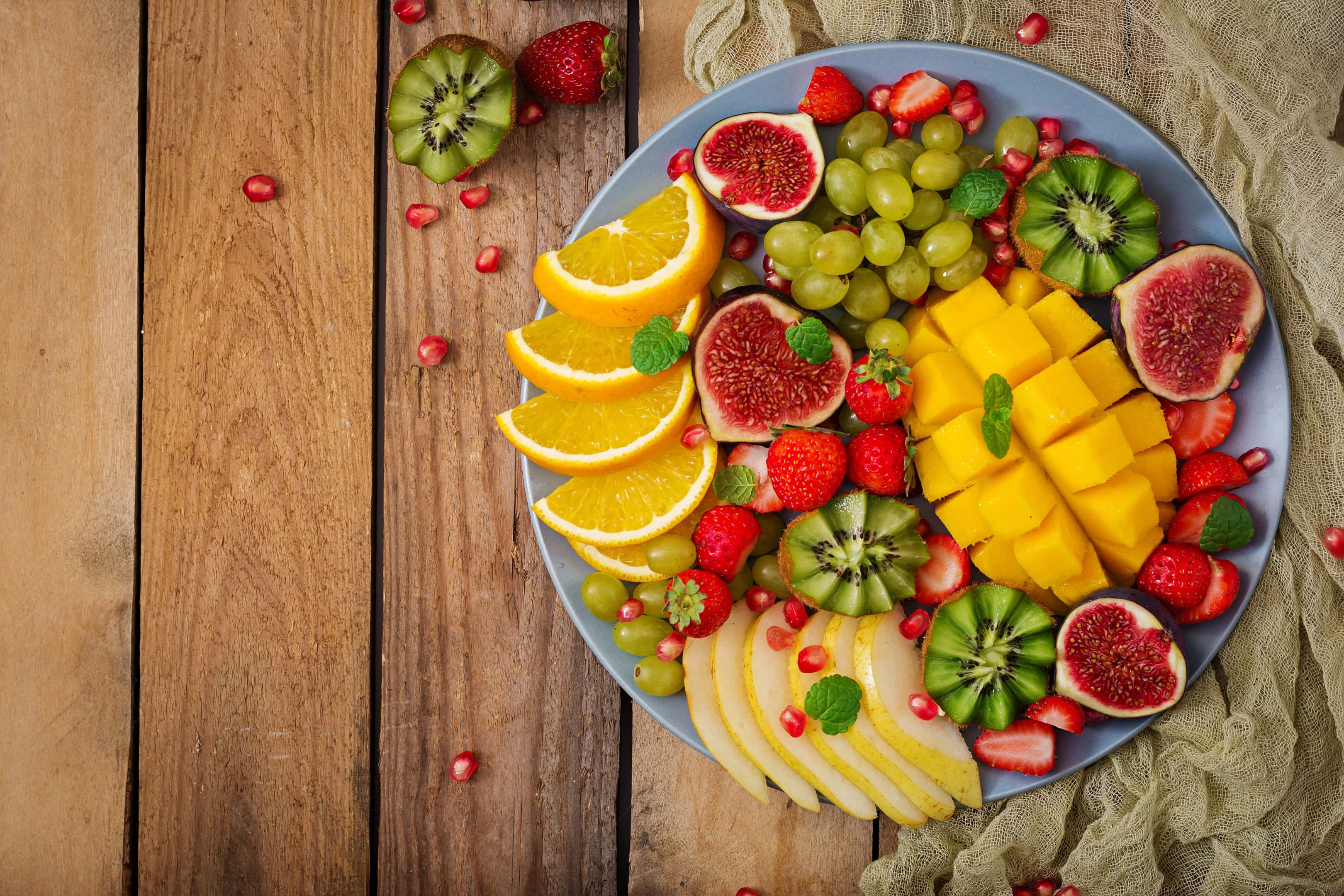 Platter of fruits and berries. Mango, kiwi, fig, strawberry, grapes, pear and orange.